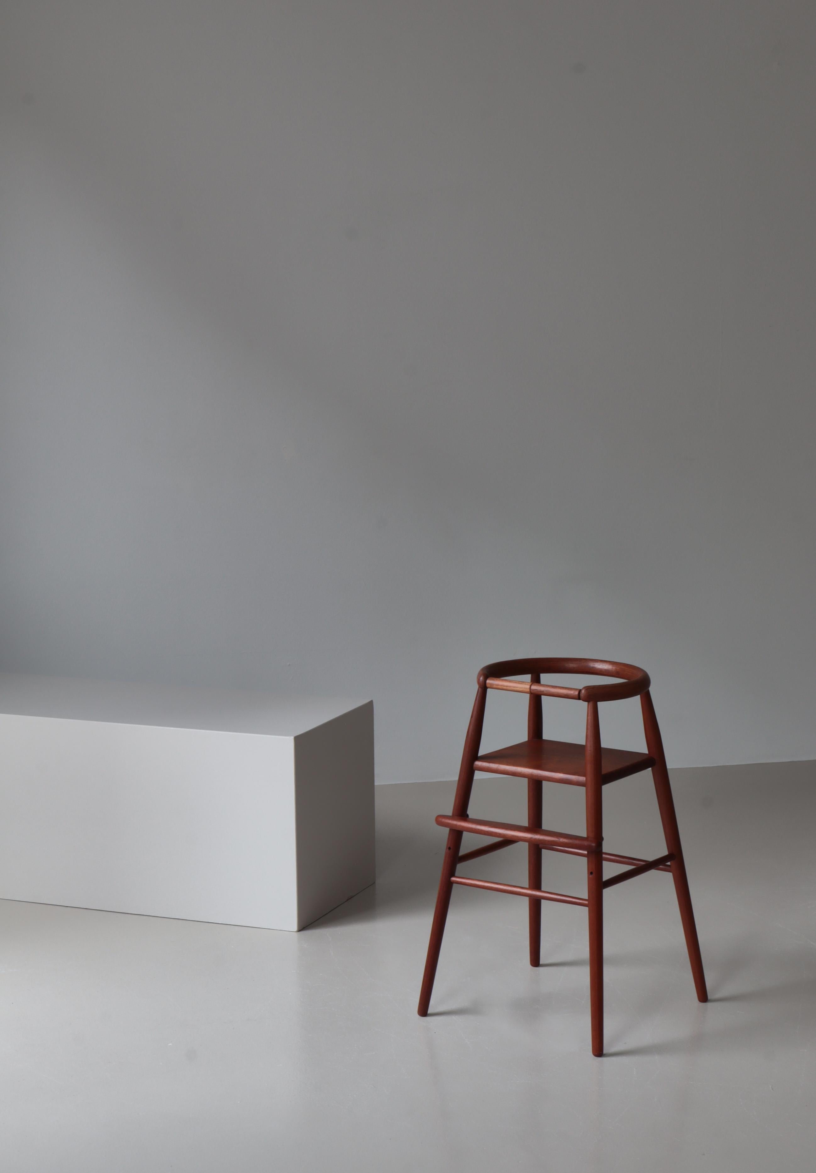 A gorgeous solid teak child's high chair designed by Nanna Ditzel (known as “the First Lady of Danish design”) for Kold Savvaerk, Denmark, 1955. Ditzel designed the chair for her twin girls, Vita and Lulu, born in 1954. It won the Lunning Prize for