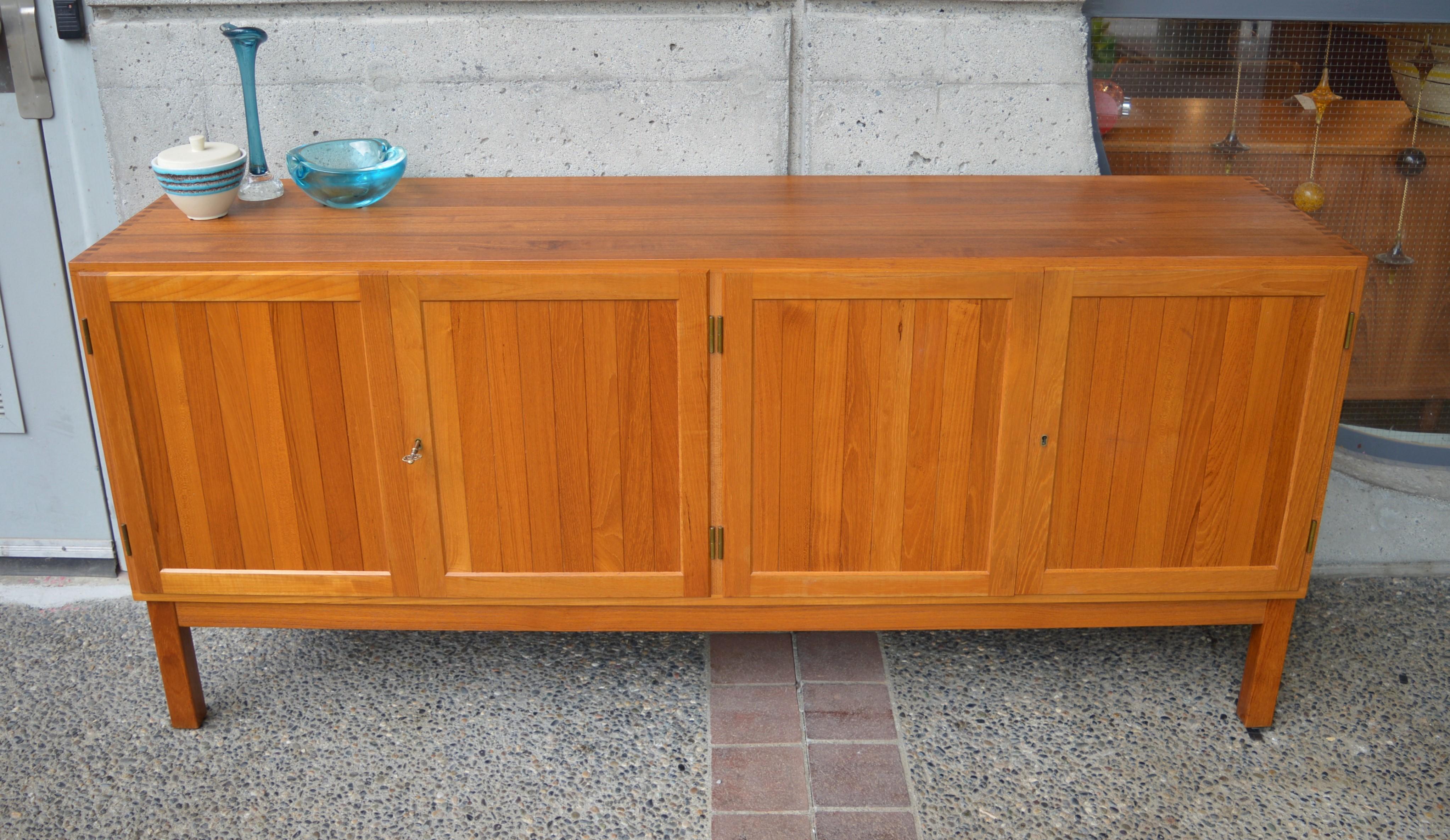 This impeccable Danish modern teak credenza is made entirely from solid teak! Note the amazing 3/4