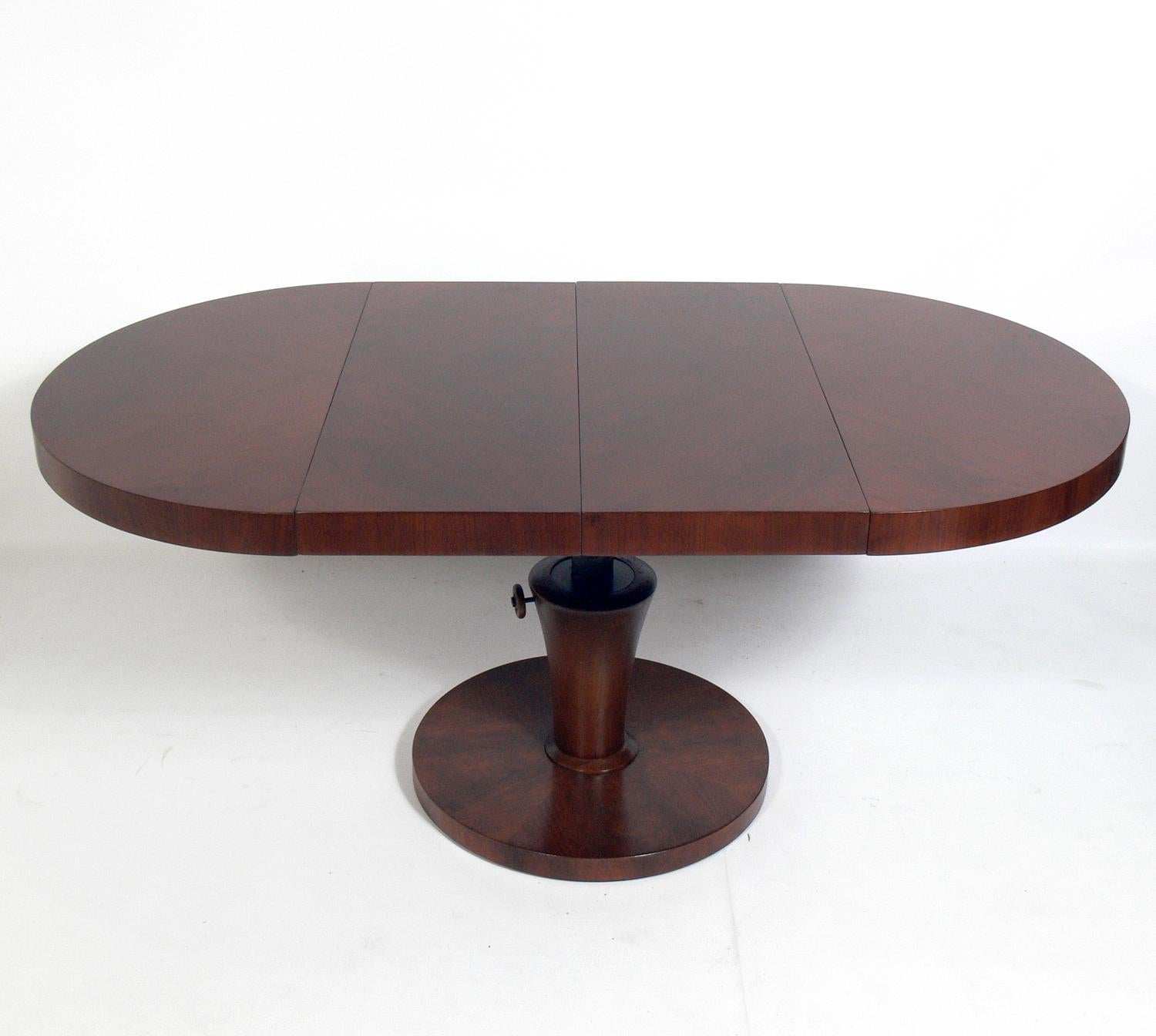Danish modern style convertible coffee or dining table, Sweden, circa 1950s. It is a versatile size and can go from coffee table height to dining table height with just a few turns. It also comes with two leaves to seat up to six. Great table for an