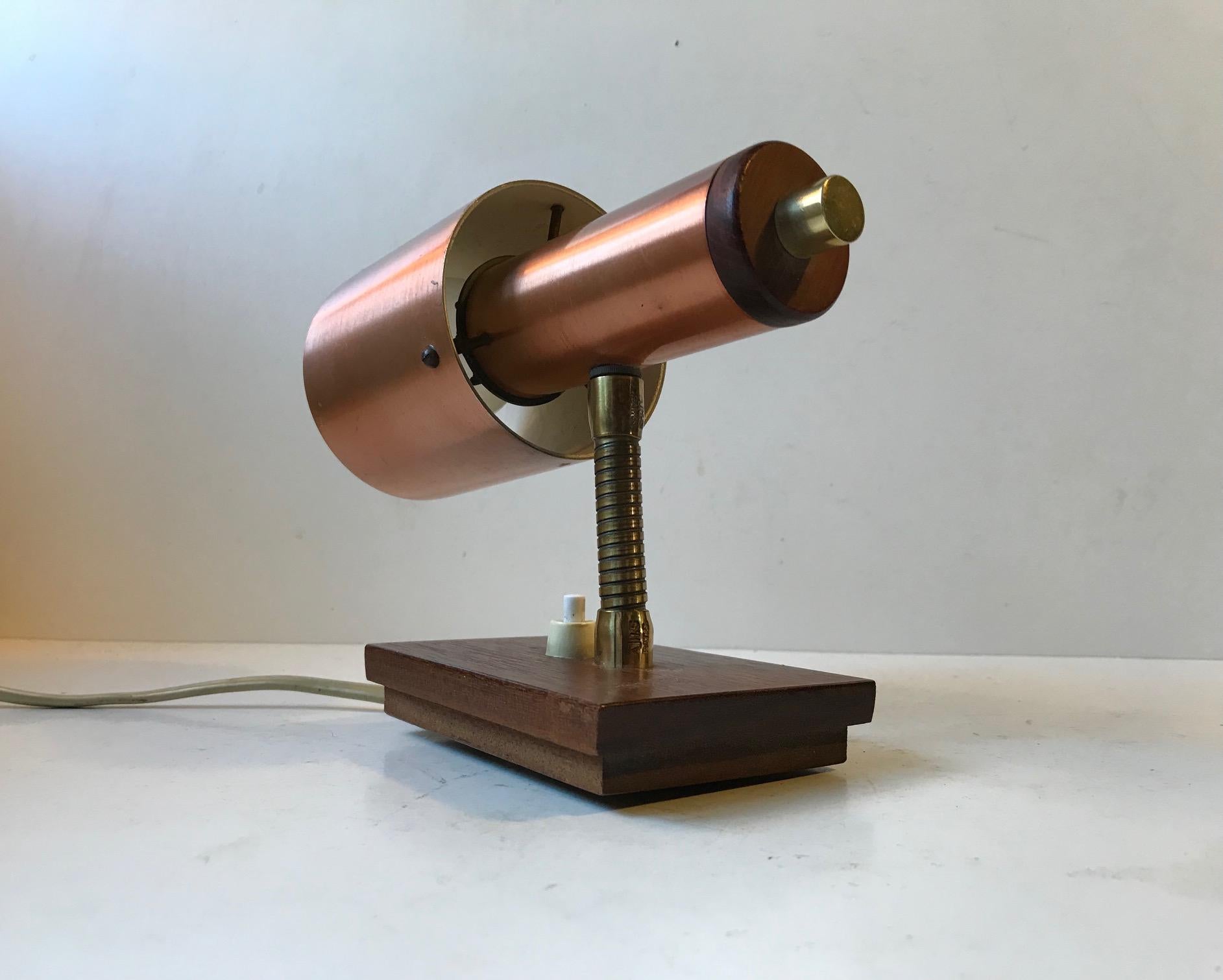 Vintage adjustable wall light composed of copper alloy on aluminium, teak and brass. It was manufactured and designed by E. S. Horn in Denmark during the early 1960s. It is labelled with a paper maker's mark to the backside of the base.
