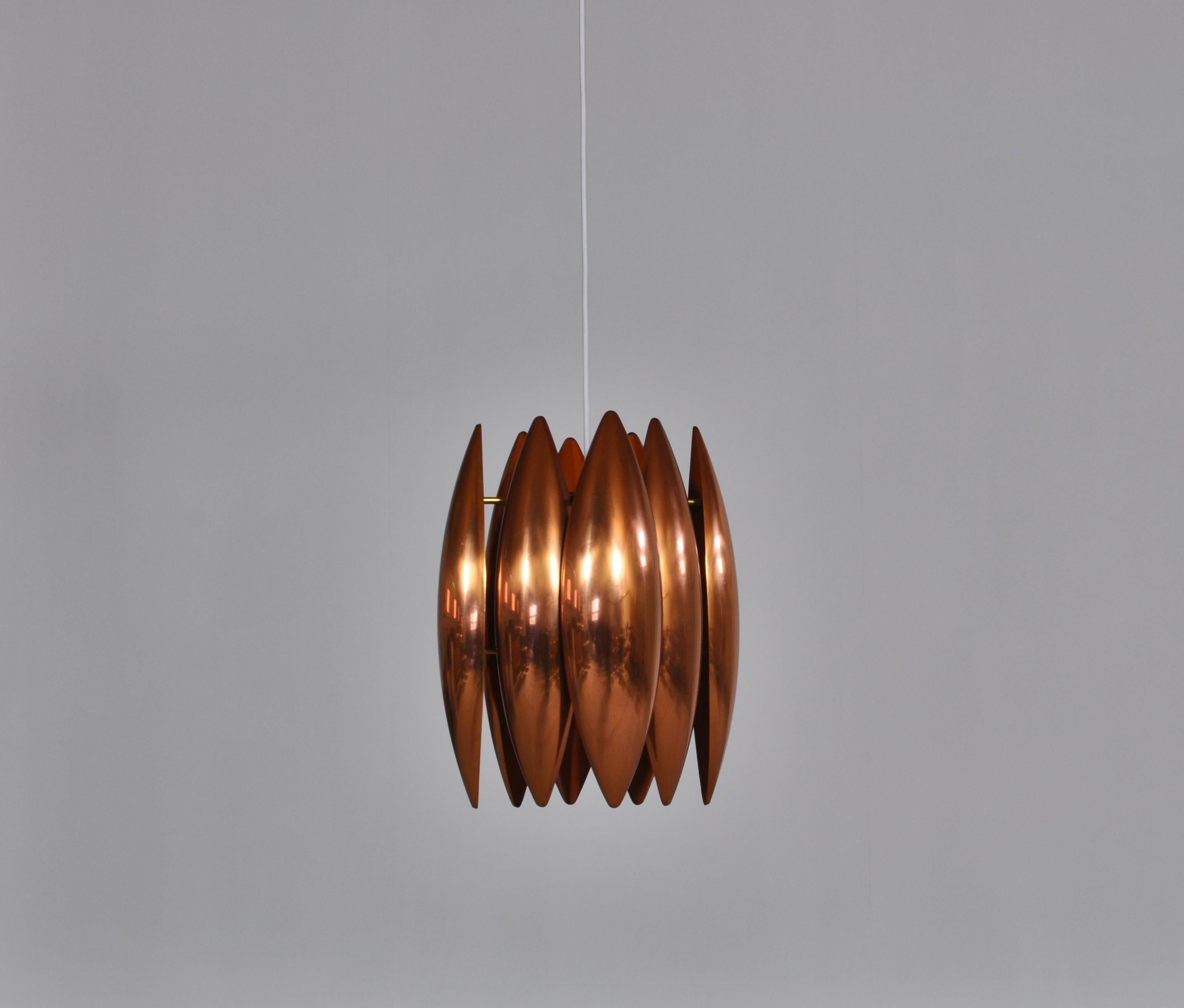 Impressive copper pendant by Danish designer Jo Hammerborg. The lamp was made in the late 1960s for Fog & Mørup, Copenhagen. Hammerborg was educated as a silver smith and this is clearly seen in many of his designs. Brutalism and Danish modern is
