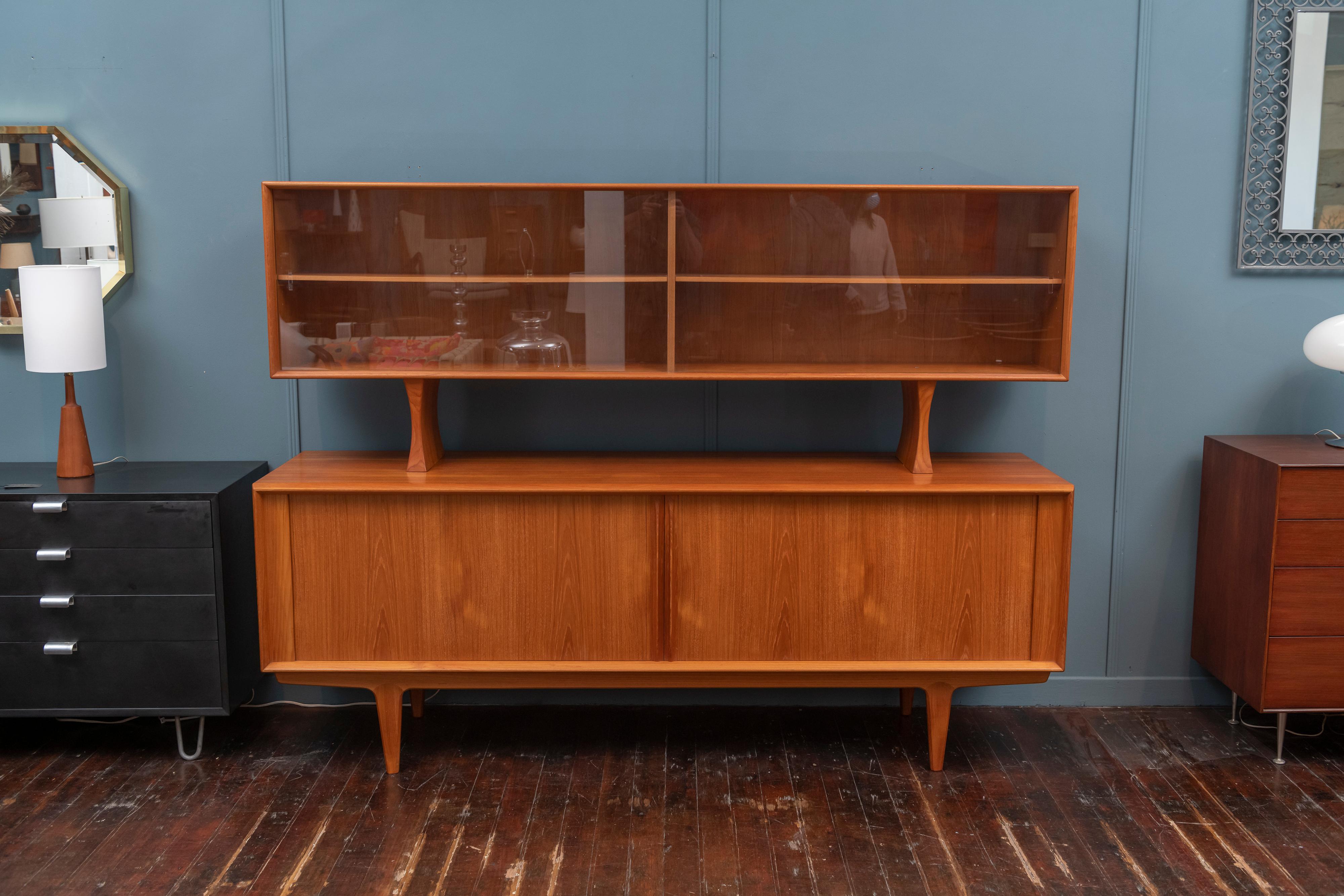 Danish modern teak credenza with matching removable hutch or display cabinet. High quality construction and design throughout with adjustable interior shelves and four slim drawers. Timeless and Classic Danish design, perfect for dining or for