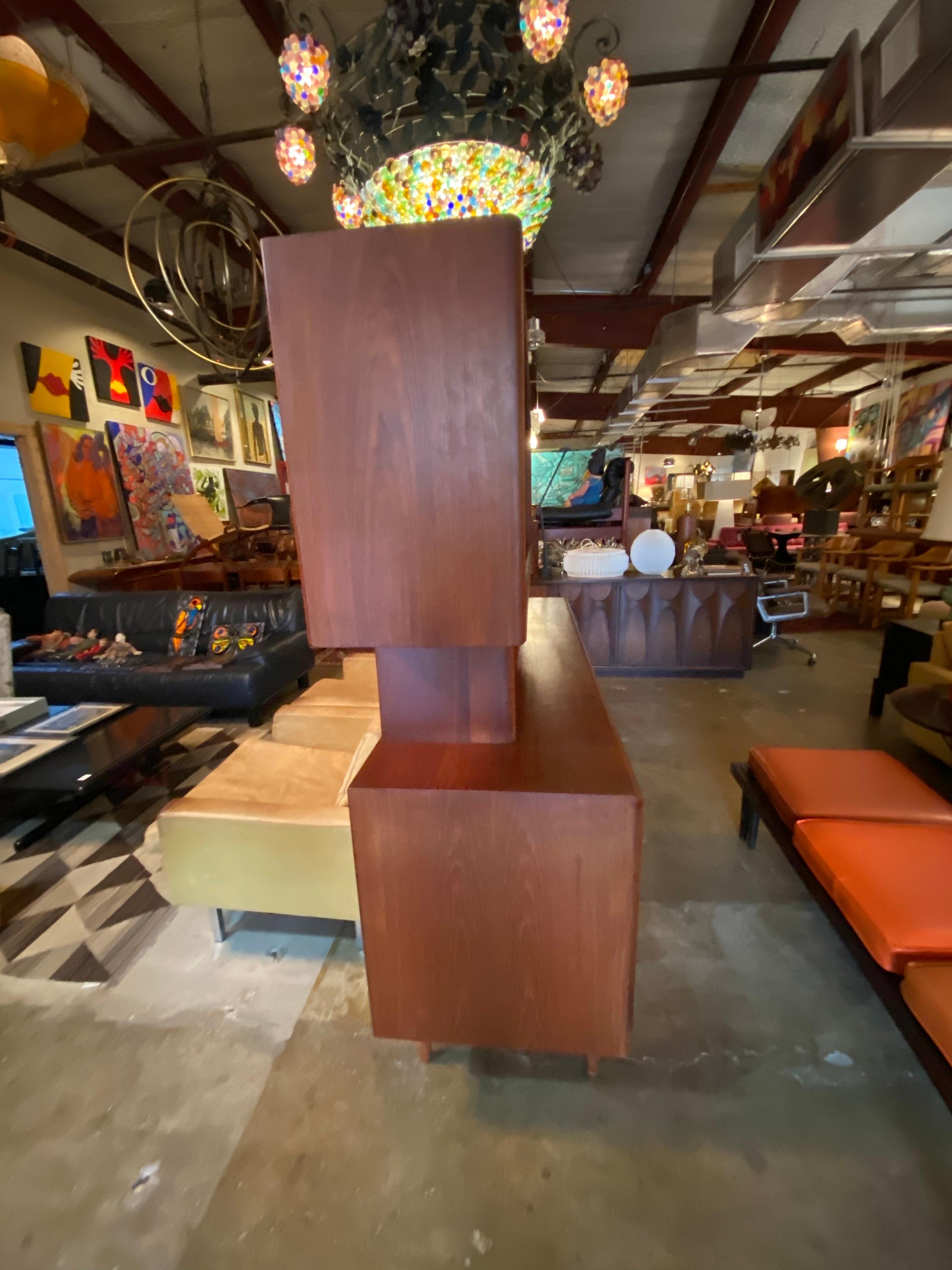 Beautiful Scandinavian modern credenza or sideboard with a detachable hutch designed by Johannes Aasbjerg is made of solid teak and finished on the back features sliding doors with two compartments that contain two shelves complete with sculpted