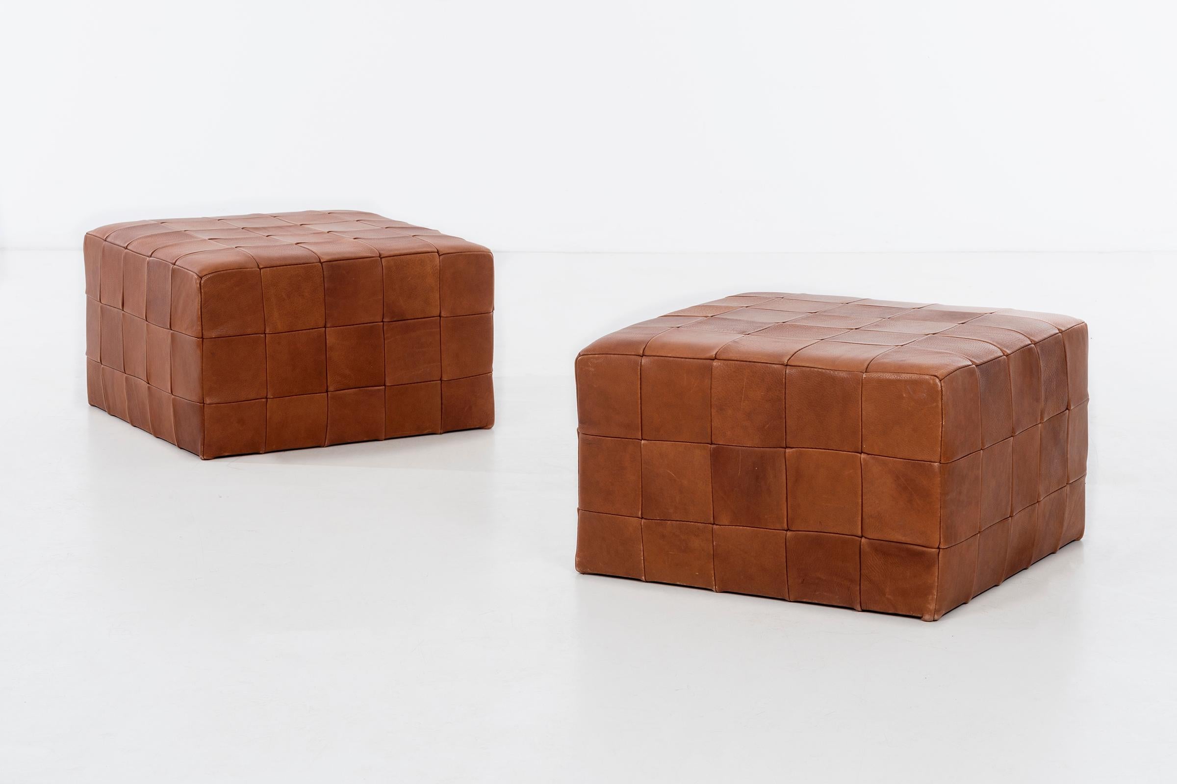 Pair of vegetable dye leather patchwork stools/ ottomans.
 