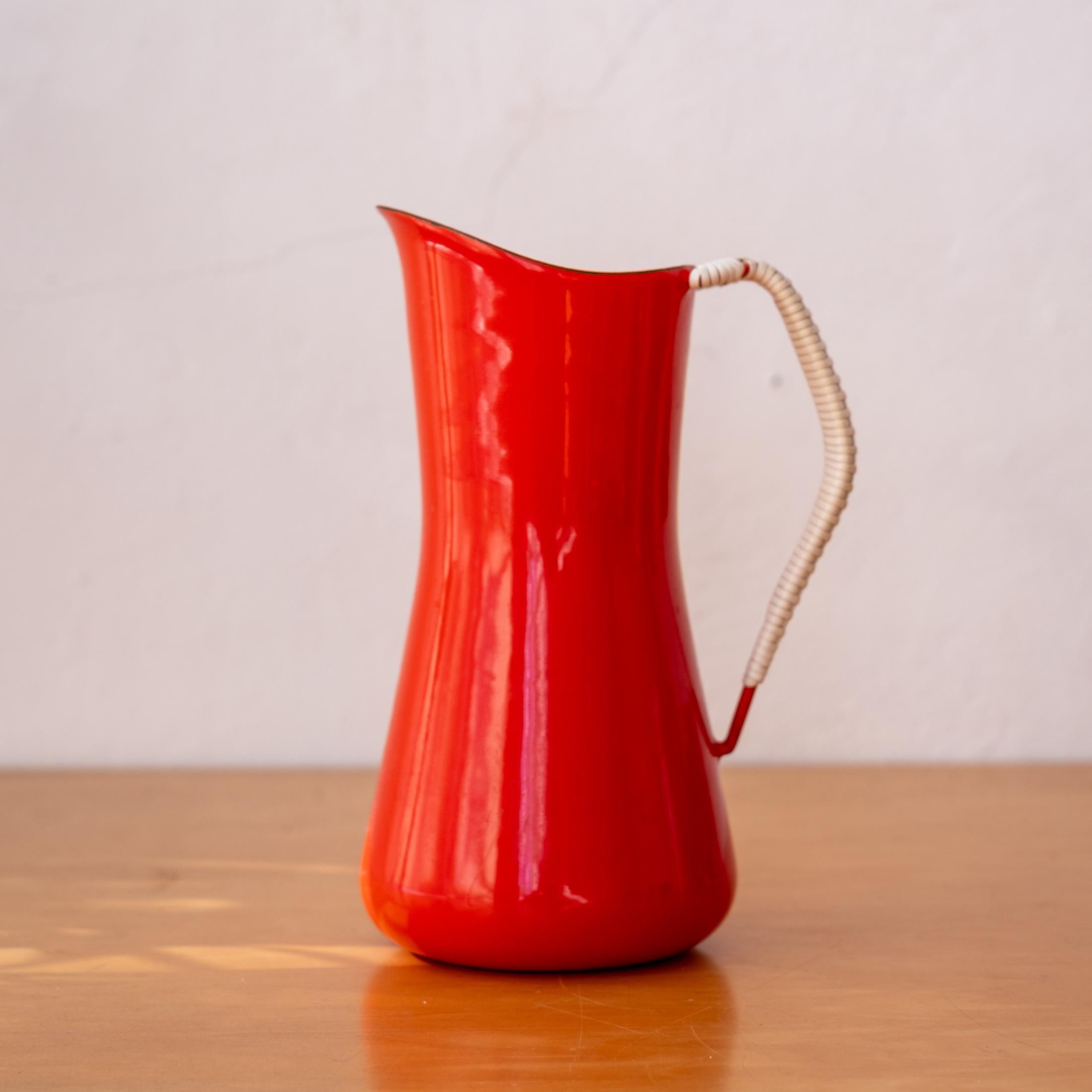 Dansk Kobenstyle red enamel pitcher designed by Jens Quistgaard. Super clean with a wrapped handle. This is the largest water pitcher made by Dansk and exceeding hard to find.  Signed with an early logo with the ducks on bottom. Denmark, 1950s