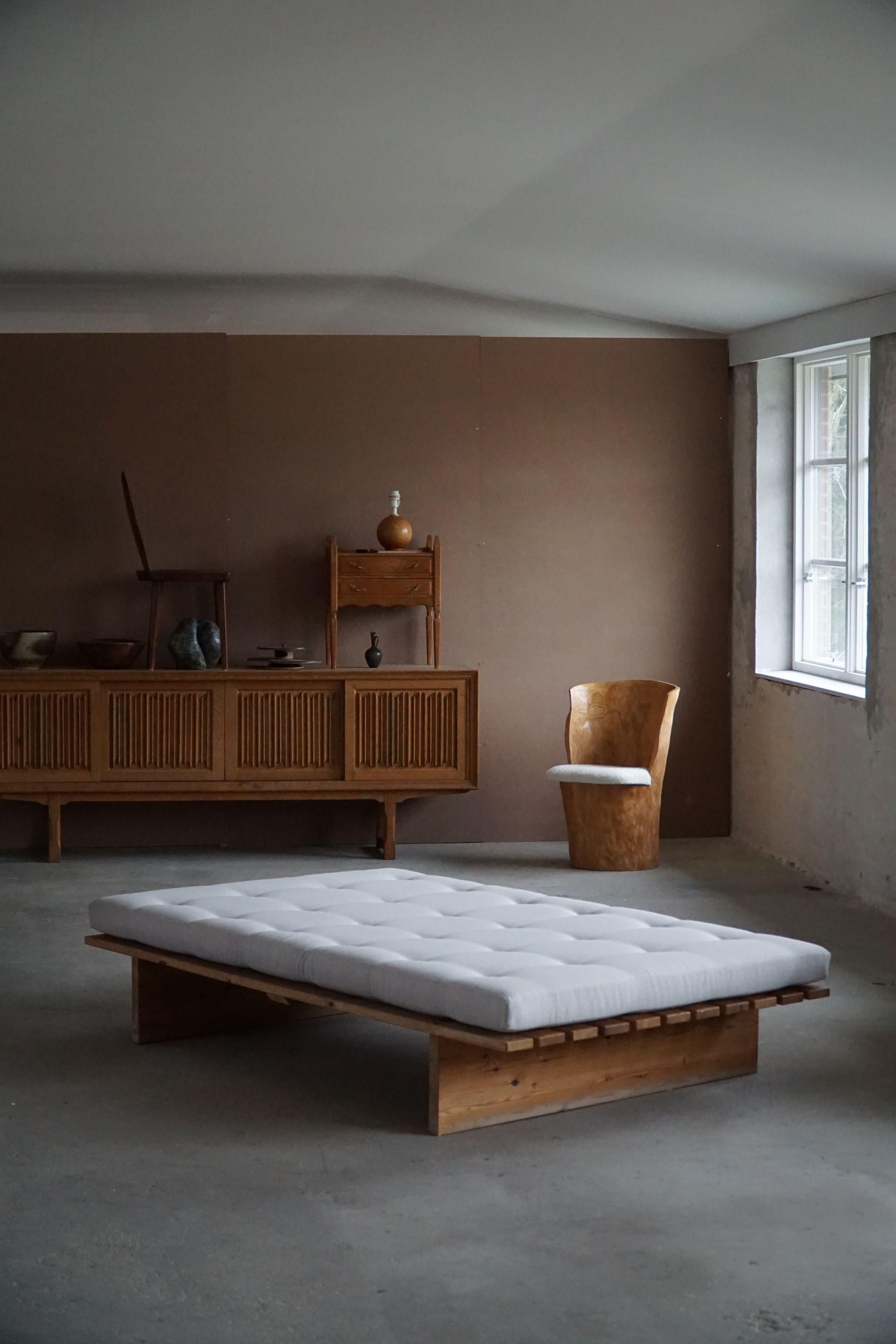 A large Danish mid century daybed in solid pine, reupholstered in grey wool. Made by a Danish company 