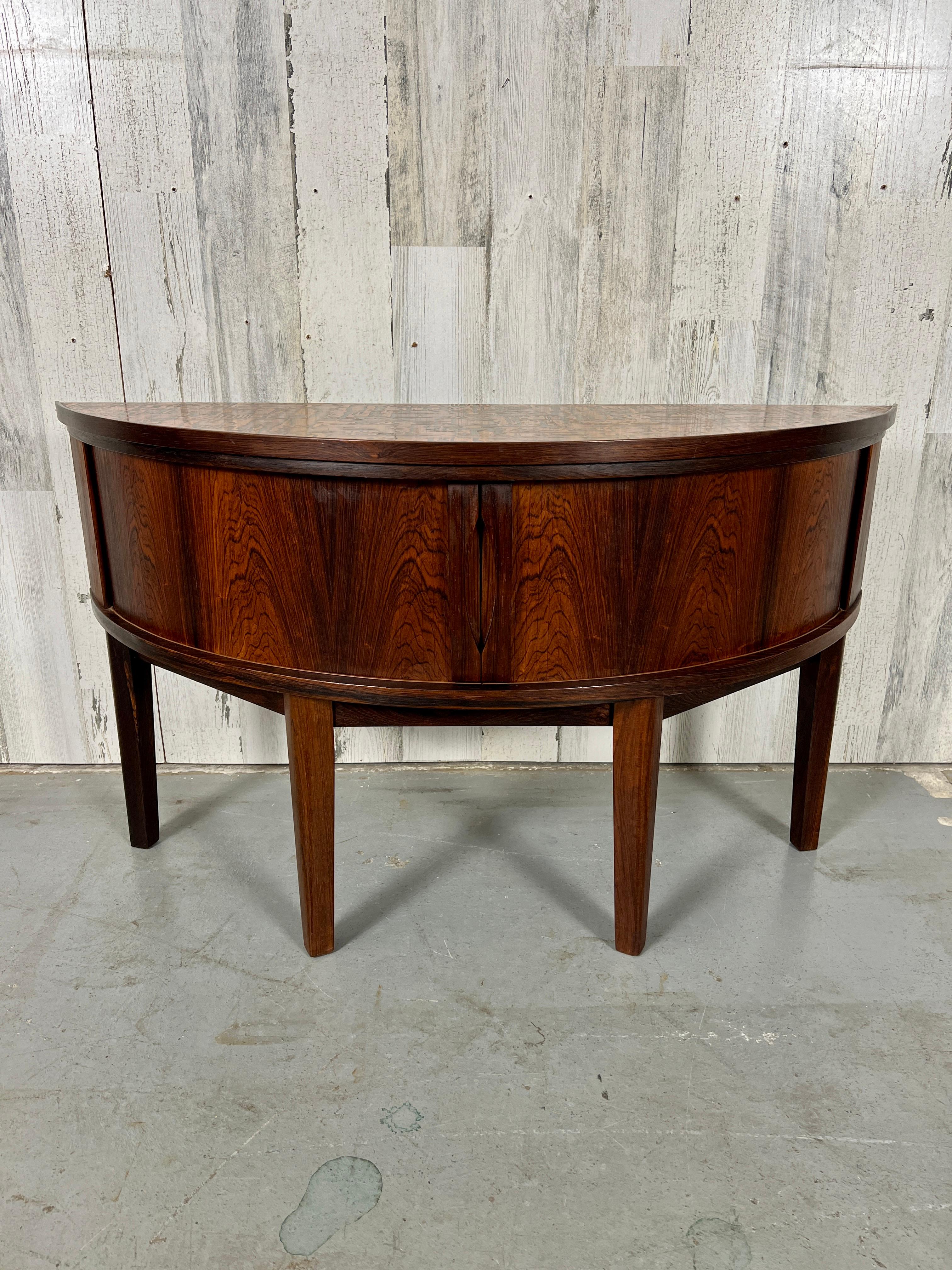 Rare petit embossed copper top rosewood demi lune console / side table with tambour doors. Beautiful original condition with minor wear.