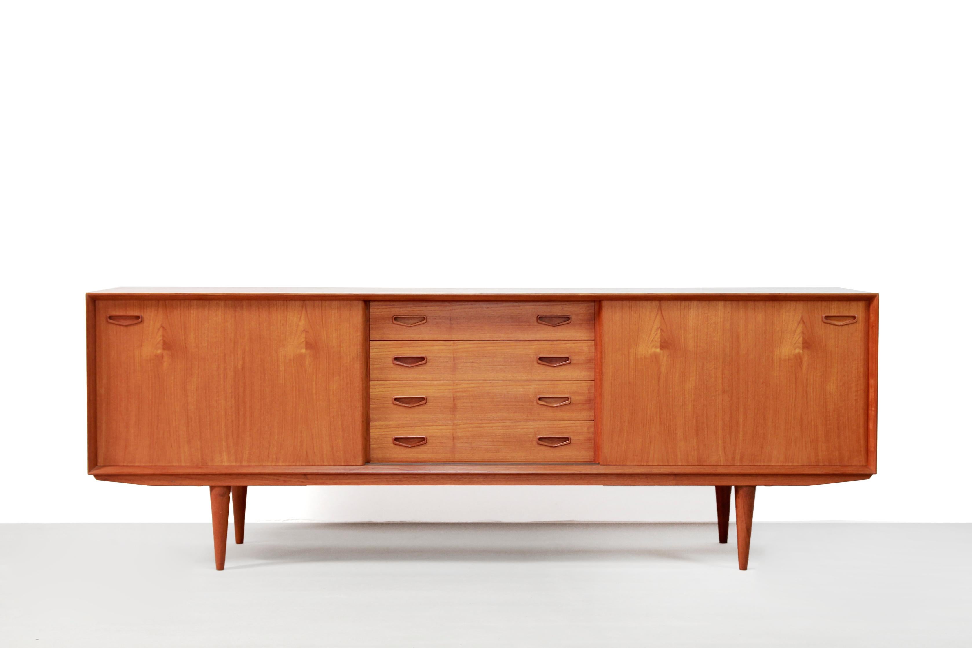 Very nice and wide sideboard produced by Danish manufacturer Clausen & Søn from Silkeborg. This sideboard is made of teak. This sideboard is very nicely finished, really high quality craftmanship. The edges of the doors are perfectly rounded, the