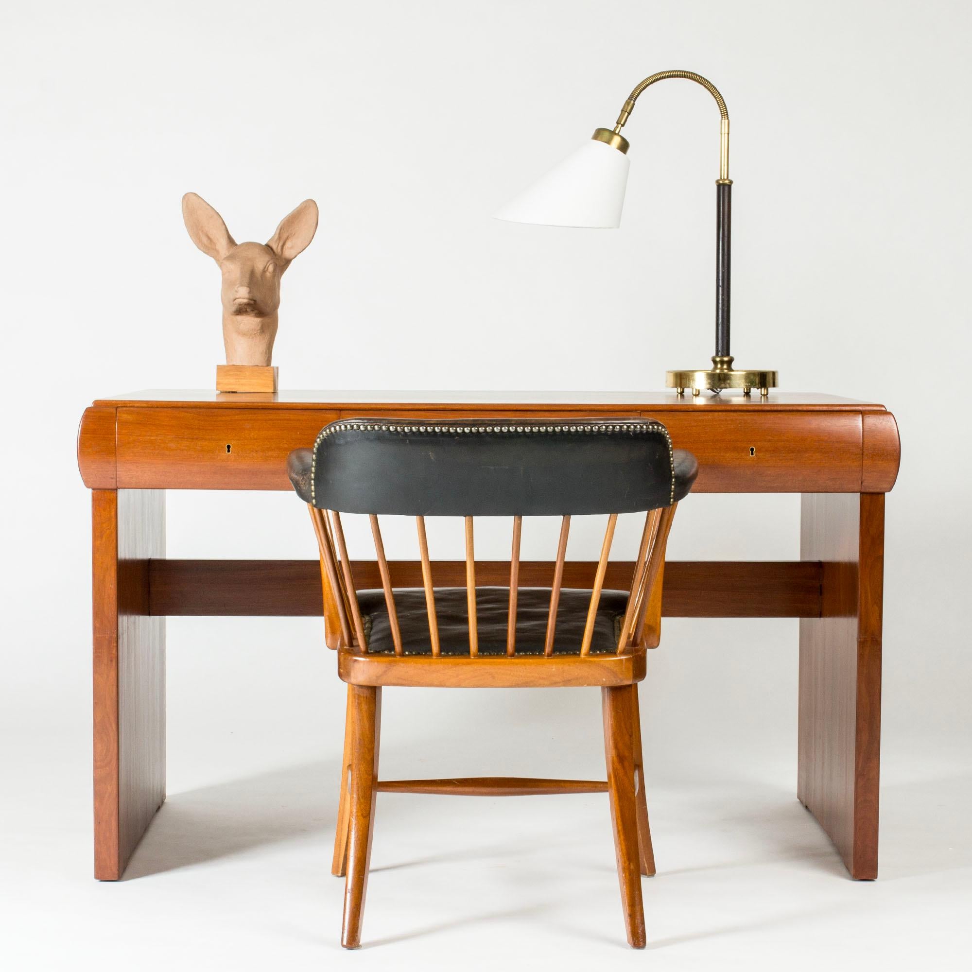 Rare Danish Modern desk by Ernst Kühn, made from mahogany with unusual lines and proportions. Hidden handles for the drawers make them easy to pull out, the key is missing.