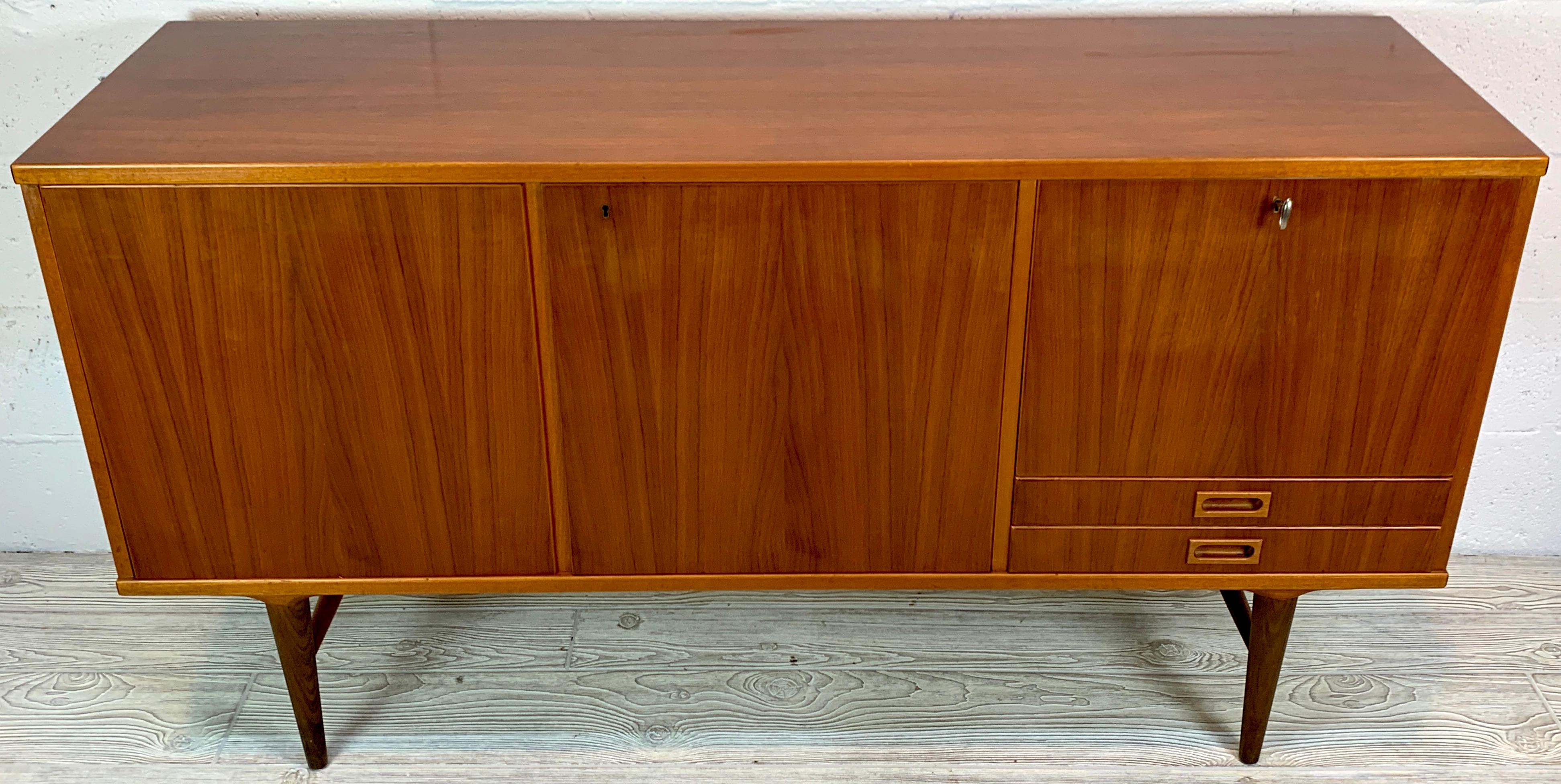 Danish modern Diminutive credenza, by Ib Kofod-Larsen, of rectangular form, The right side fitted with one drop front cabinet 17.5