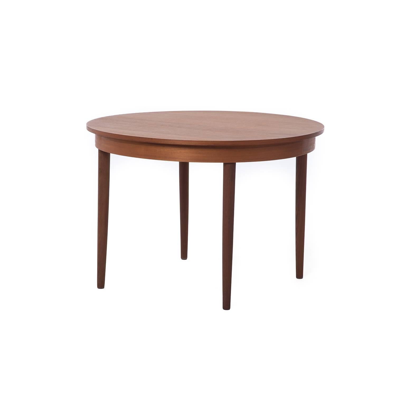 Circular teak dinette table perfect for an eat in kitchen or small dining space.