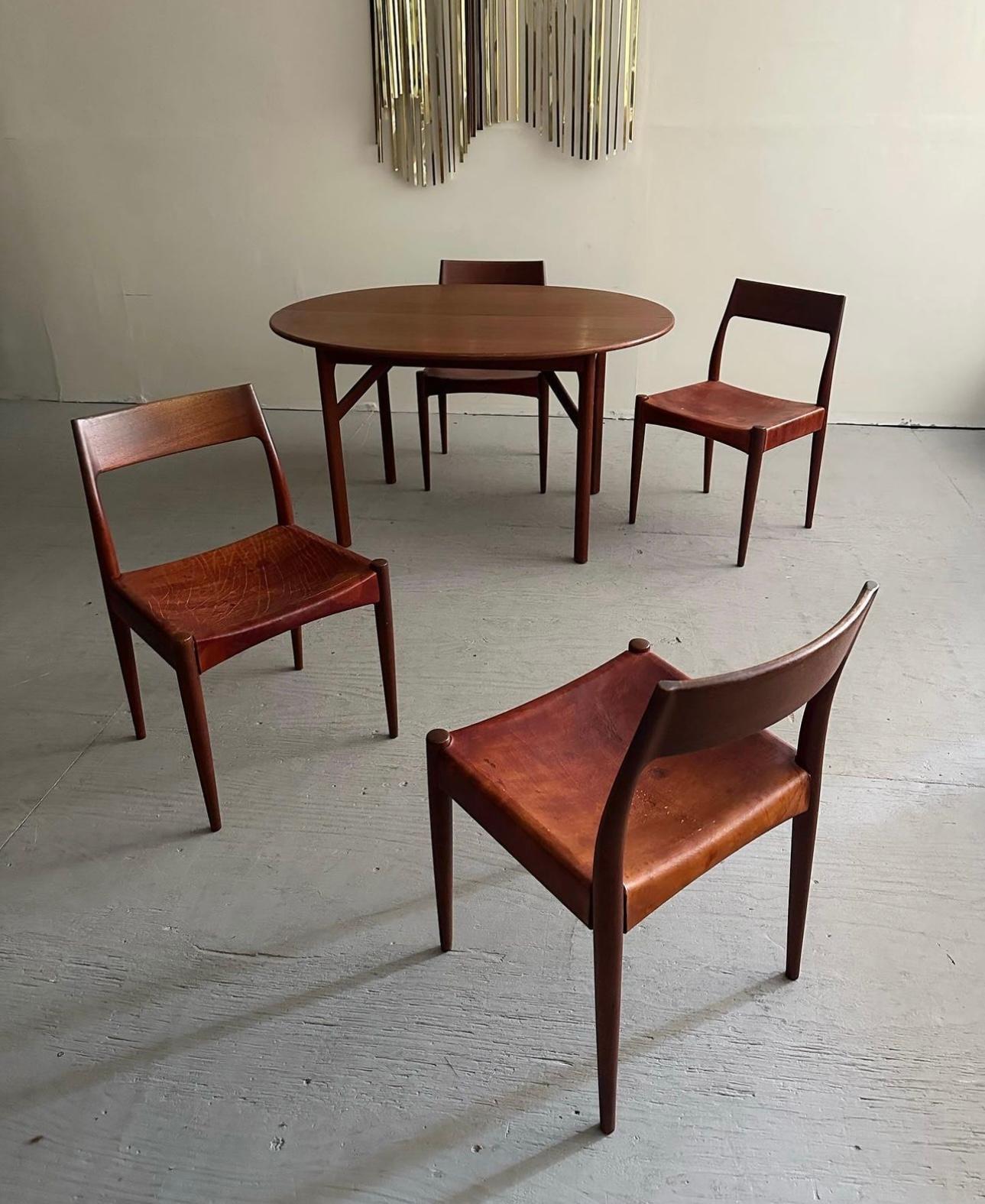 Danish Modern Dining Set Designed By Arne Hovmand-Olsen For Mogens Kold Møbelfabrik, Circa 1950s. This stunning dining set is comprised entirely of solid teak construction. Features six sculptural “Model 175” dining chairs with thick cognac colored