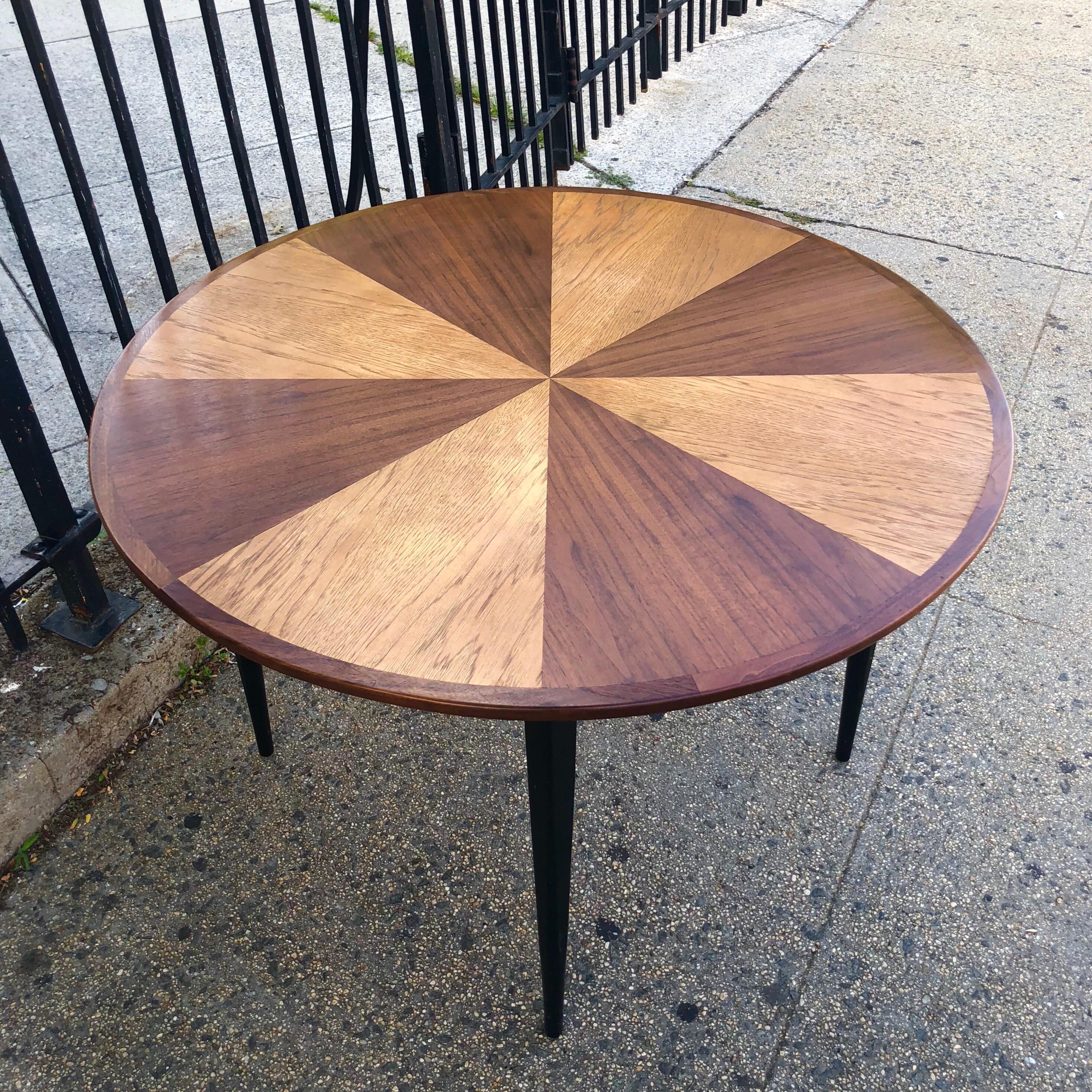 Danish modern dining table in alternative pinwheel pattern of ash and walnut finishes. Wood has been freshly oiled. Very sturdy and solid. 45 inches in diameter and expandable (does not include leaves). Comfortably fits four standard dining chairs.