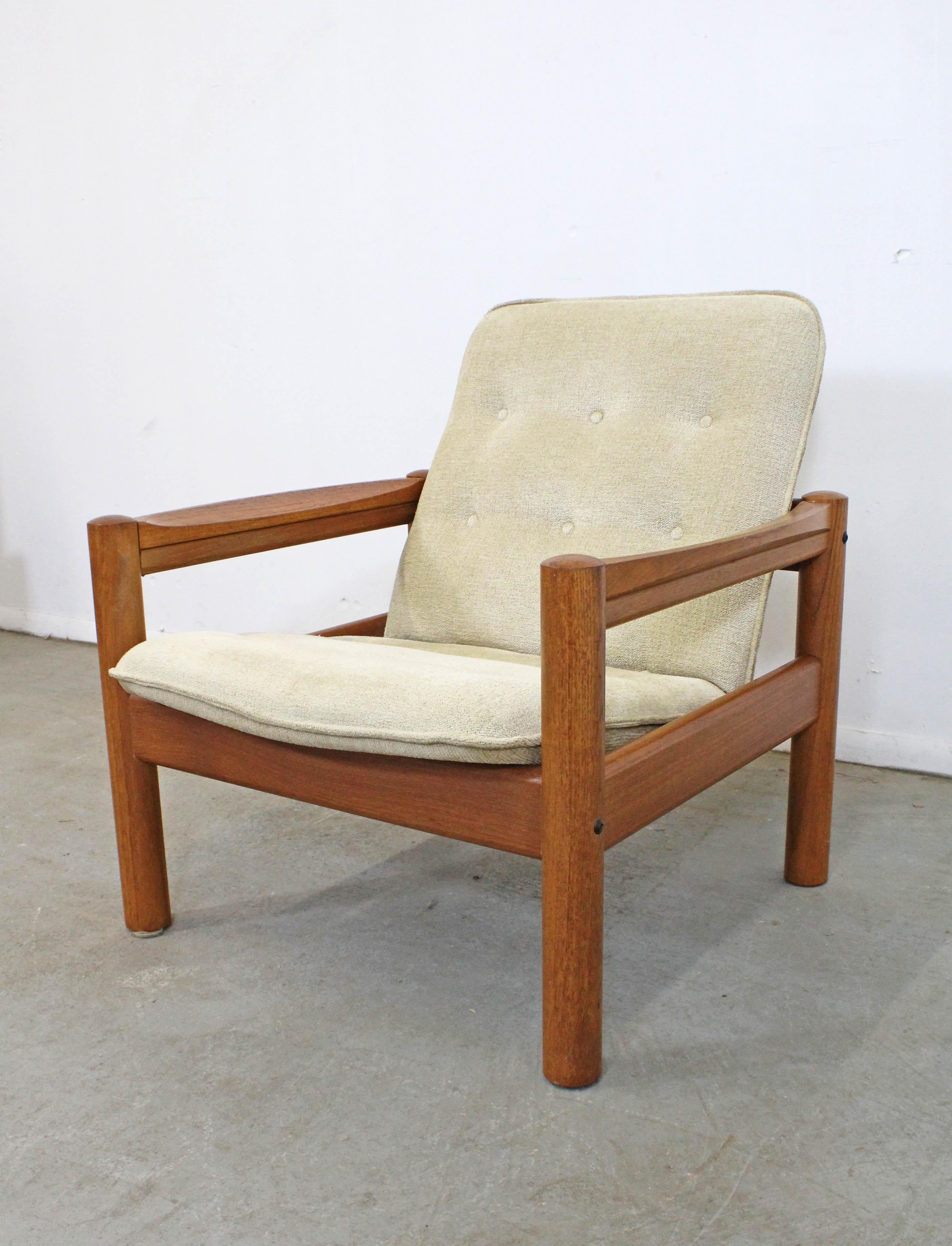 Offered is a Danish modern teak lounge chair made by Domino Mobler. Features original tufted upholstery and a solid teak frame. In good vintage condition, has minor surface wear/scratches. It is structurally sound. It is marked underneath by Domino