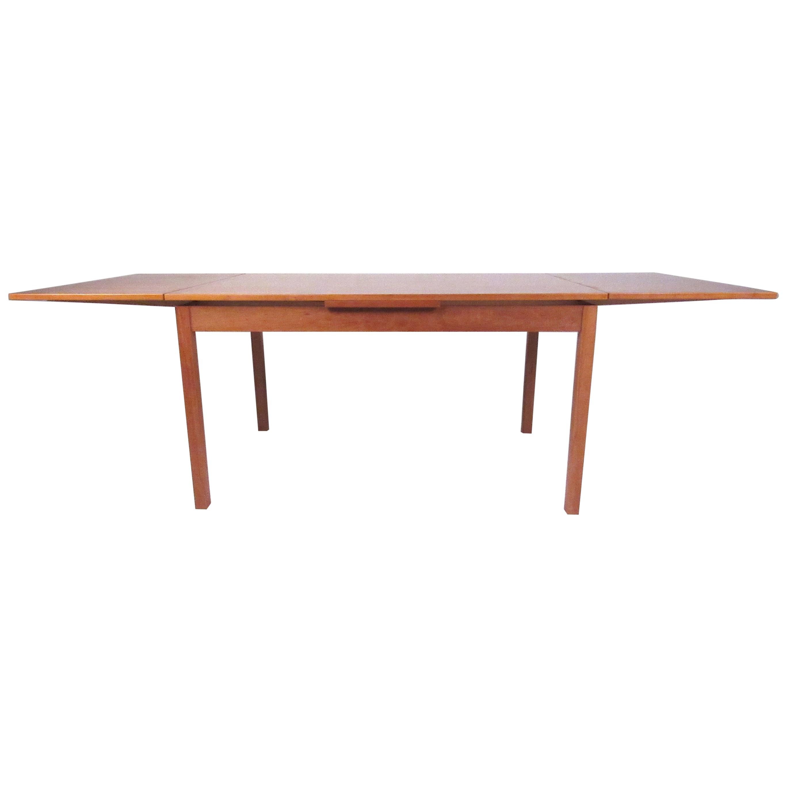 Nice Danish modern dining table. Draw-leaves on either side of the table - they extend the width from 53 inches 92.5 inches. Stamped by the manufacturer on the bottom. Please confirm item location with dealer (NJ or NY).