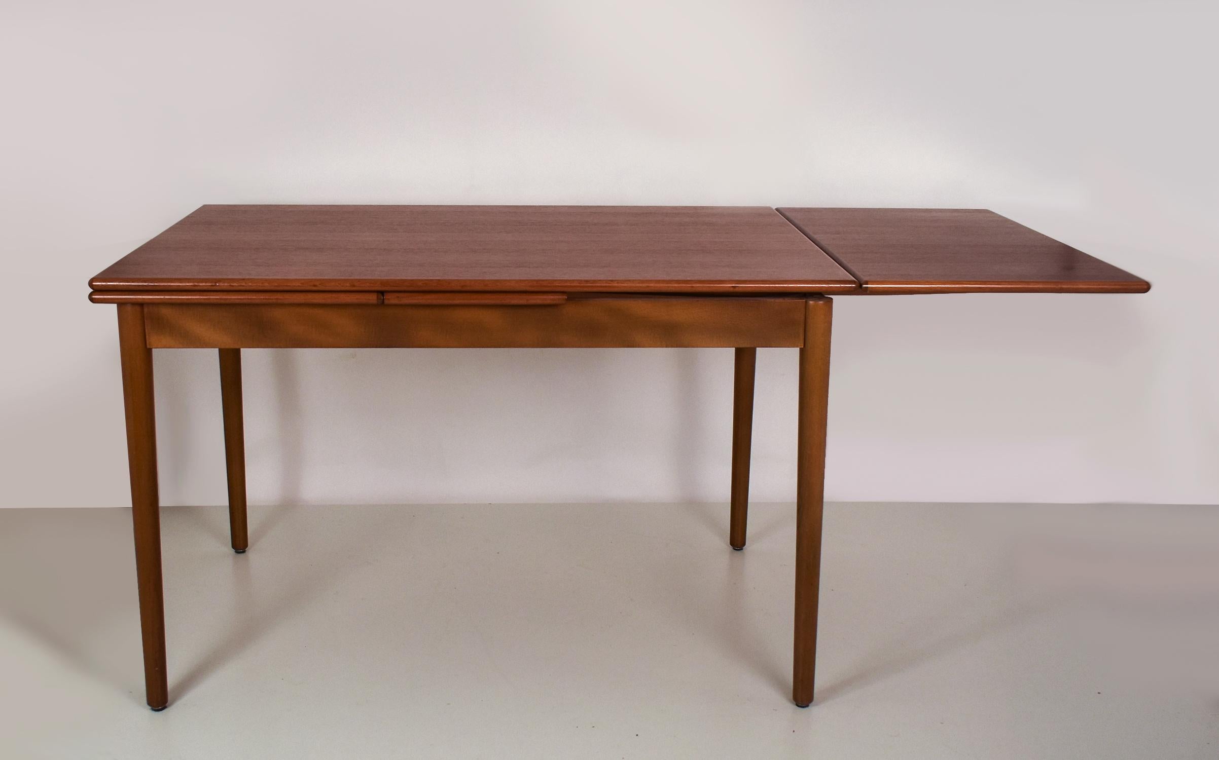 Danish modern draw leaf teak extending dining table  manufactured by AM Møbler , 1960's.
Functional and elegant table. One wing or both can be extended.
It is in very good condition.
Measures:
- closed: Width 120cm. Depth 80cm. Height 76cm.
- Open: