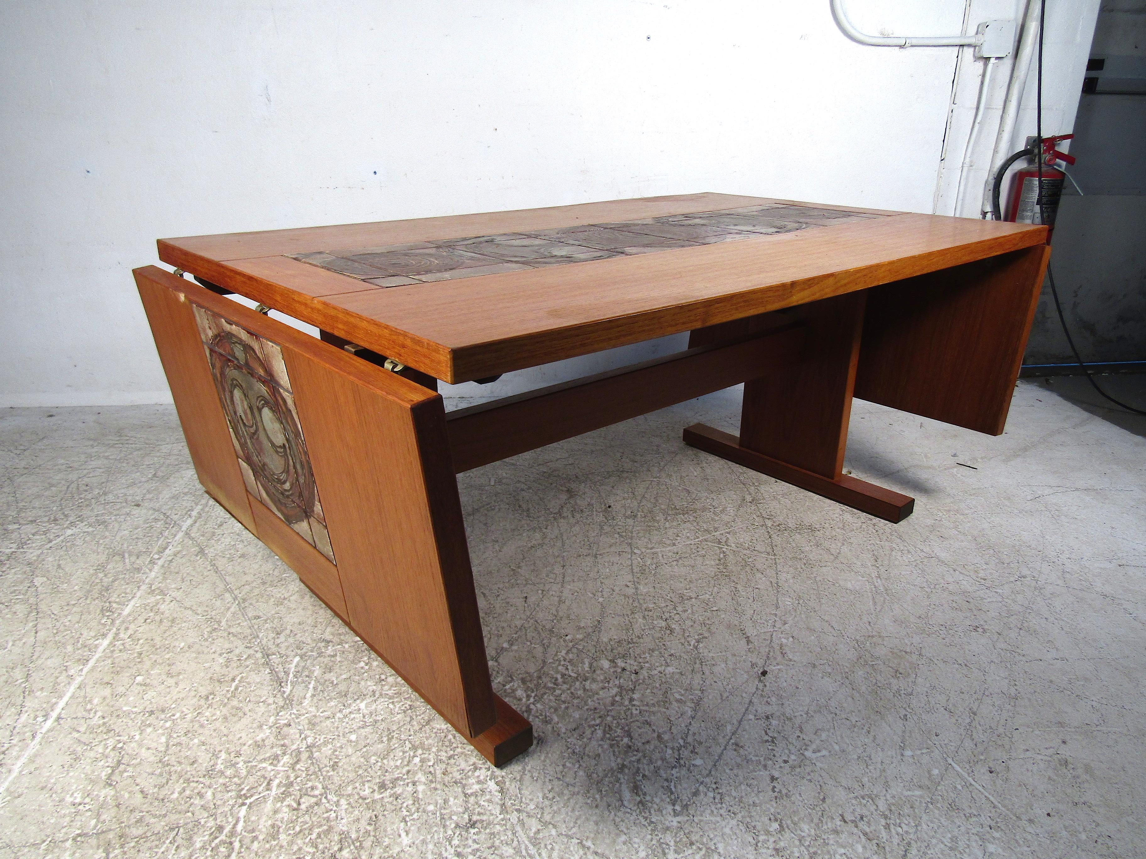 Interesting Danish modern dining table. Two drop-leaf extensions on both ends of the table, with tile inlays matching those on the main table. Leaves extend the table's width from 61 to 96 inches. Please confirm item location with dealer (NJ or NY).