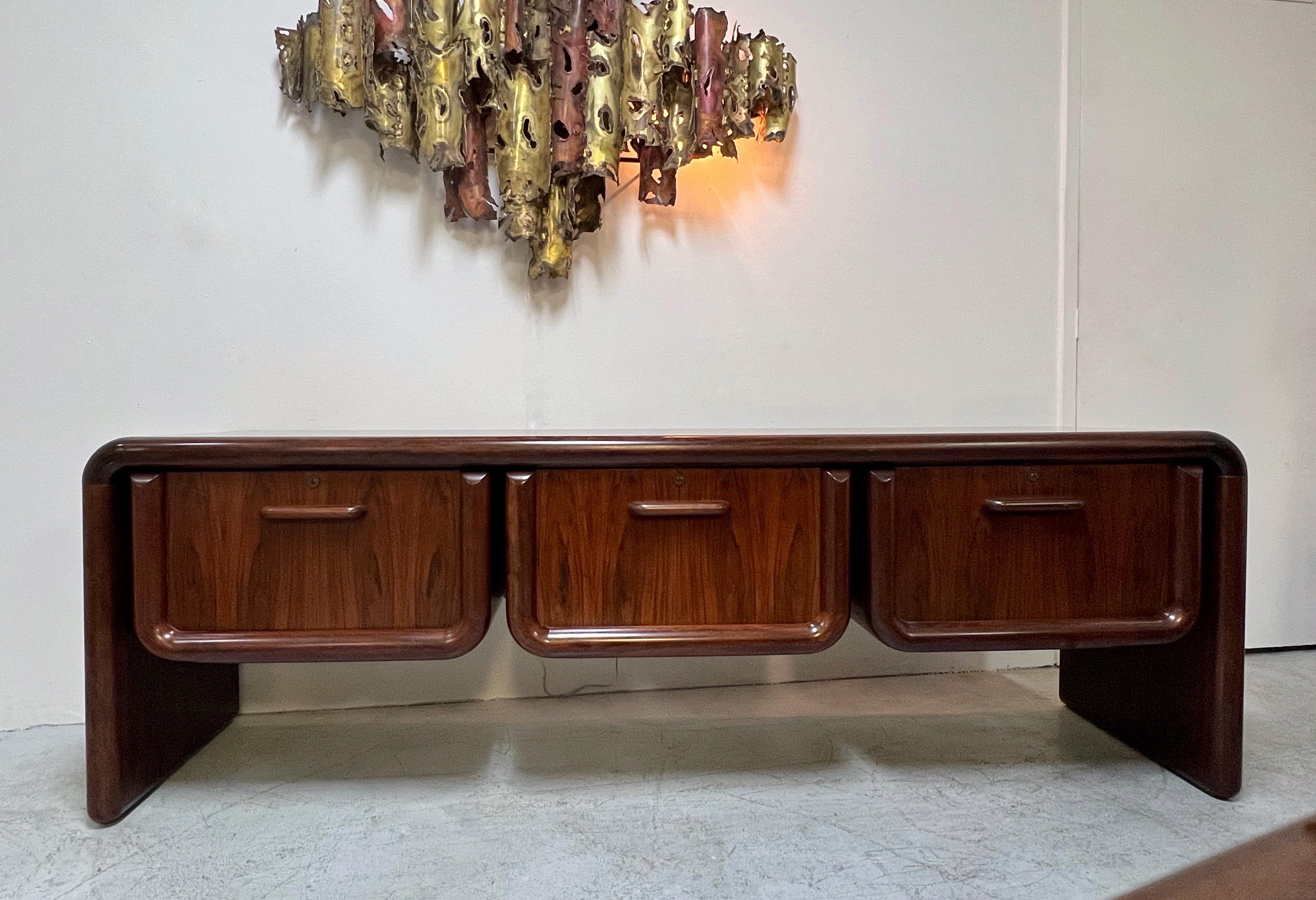 A large and handsome cabinet. The thick rounded edges are solid wood as are the pulls on the deep drawers. Beautiful active grain on all surfaces. Very solid sturdy piece of furniture.