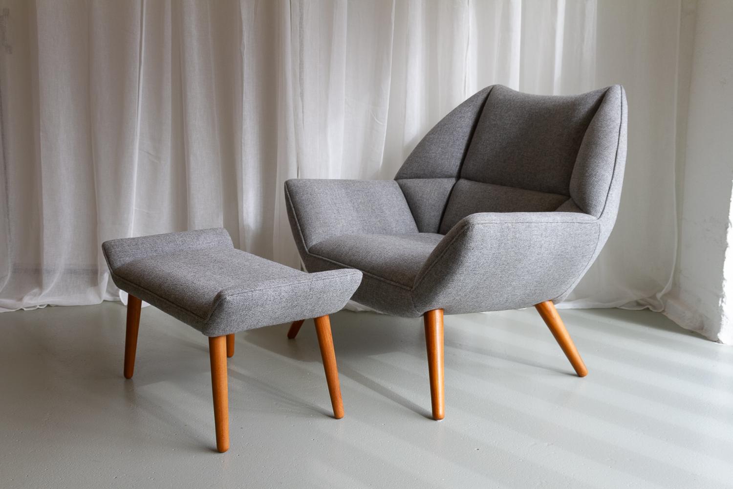 Danish Modern Easy Chair and Stool Model 12 by Kurt Østervig, 2010s.
Lounge chair and footstool in grey wool with round tapered teak leg designed in 1961 by Kurt Østervig for Schillers Polstermøbelfabrik, Denmark. 
This is a part of a limited series