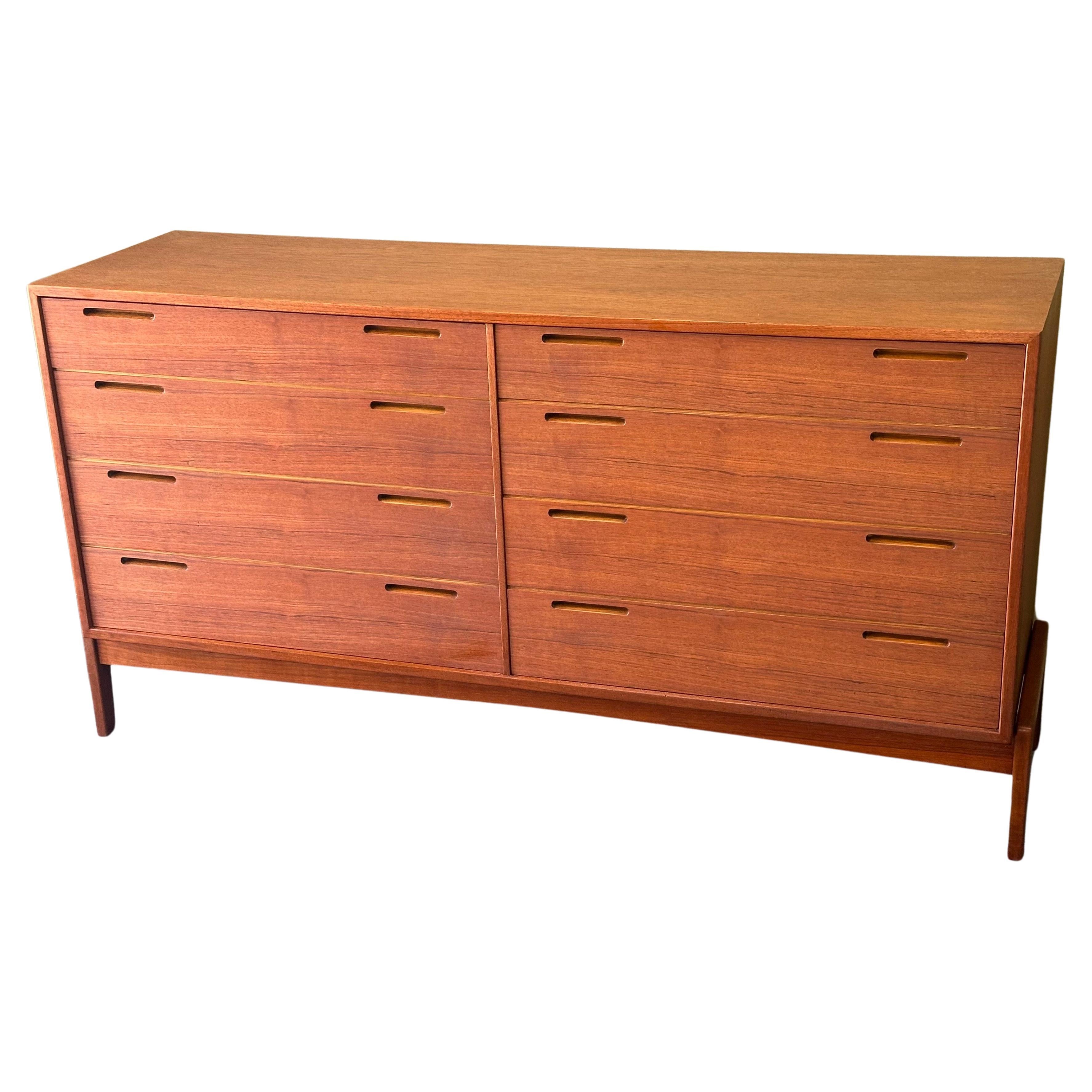 Absolutely gorgeous Danish modern eight-drawer teak dresser by William Watting, circa 1960s. The piece has been professionally refinished and looks fantastic! It is of superb quality with a finished back that would allow it to float in a room.  The