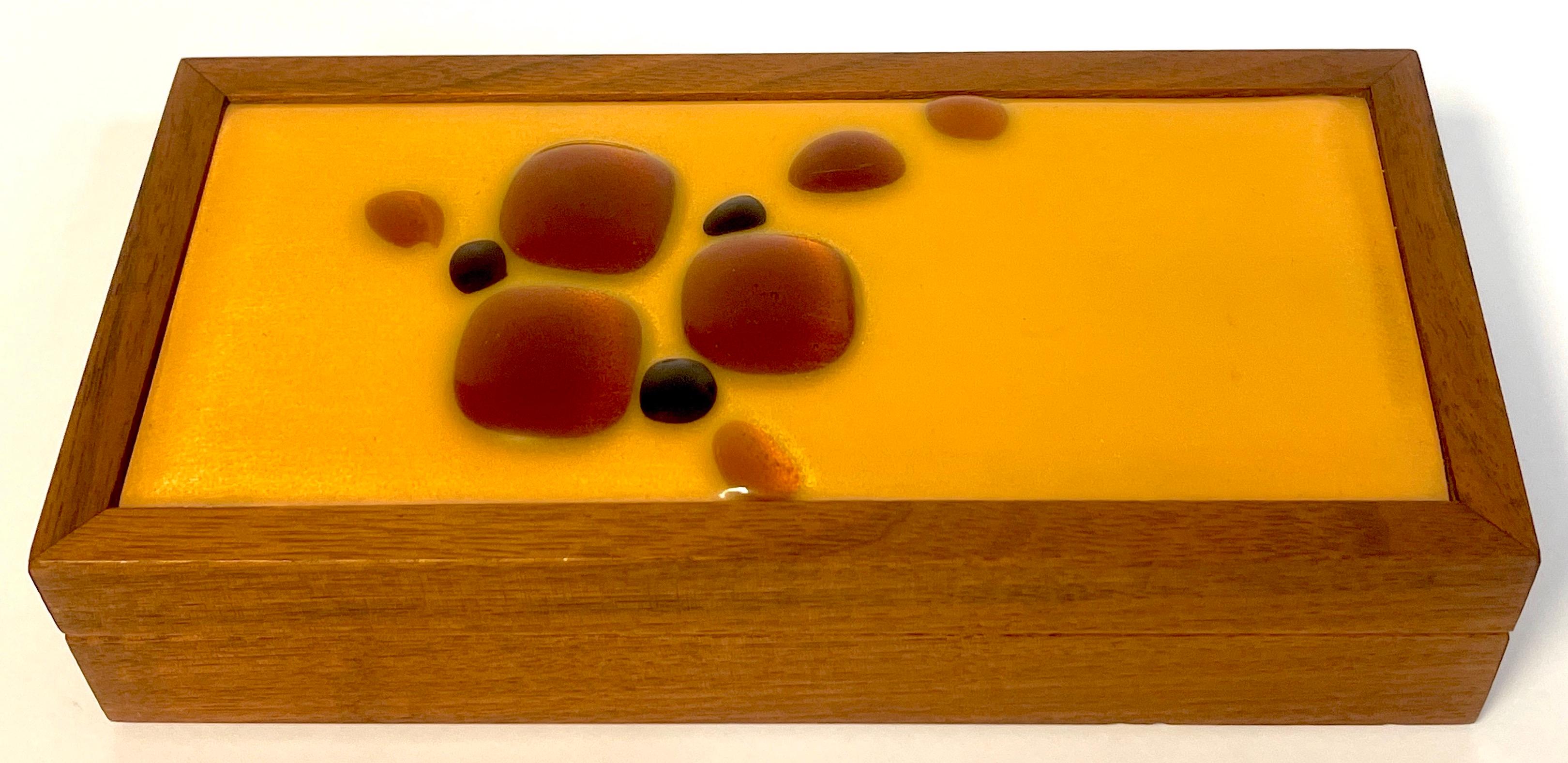 Danish modern enameled abstract teak table box
We are pleased to offer 
a Danish modern enameled abstract teak table box, this rectangular piece combines functionality and artistic expression. The top of the box features an inset enamel on copper