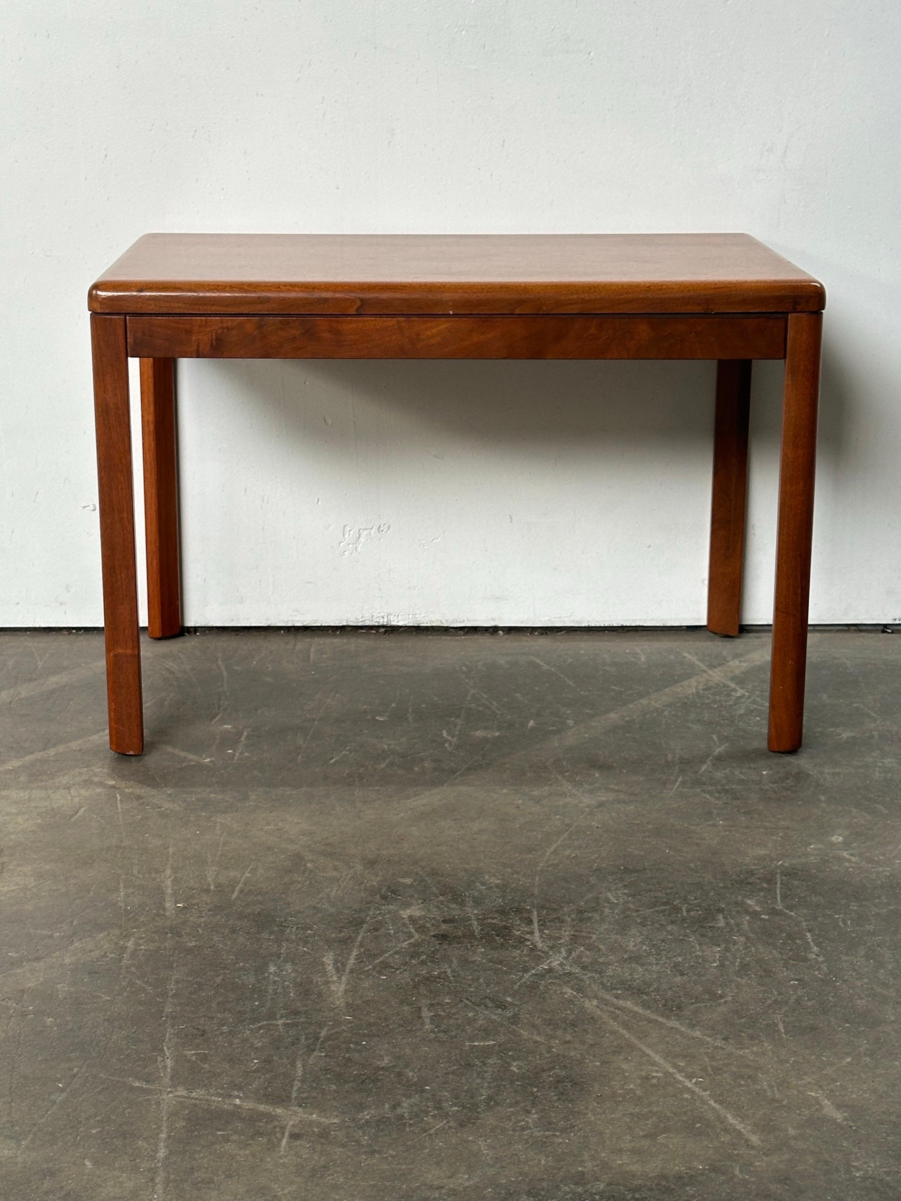 Mid-century modern side table from Denmark, executed in teak. Classic Scandinavian simplicity and elegance. Ample surface area in an efficient footprint. Suitable either as an end table in the living room, and even would be great as a nightstand.