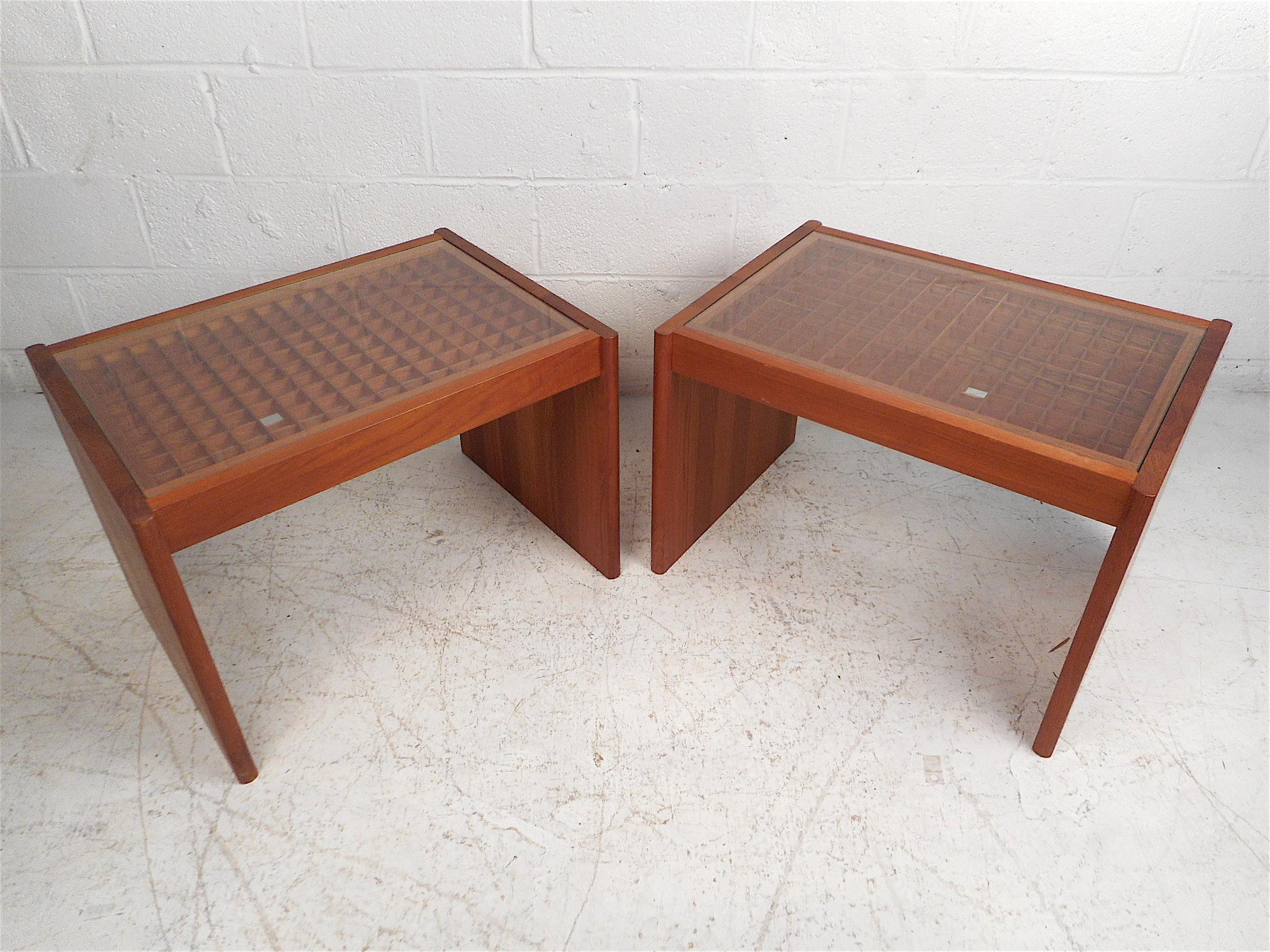 Unique Danish modern end tables by Komfort. Very unusual design with a tabletop comprised of an intricate wooden latticework design which is covered by a thin pane of glass. Handsome teak wood construction, you can see the joinery between boards on