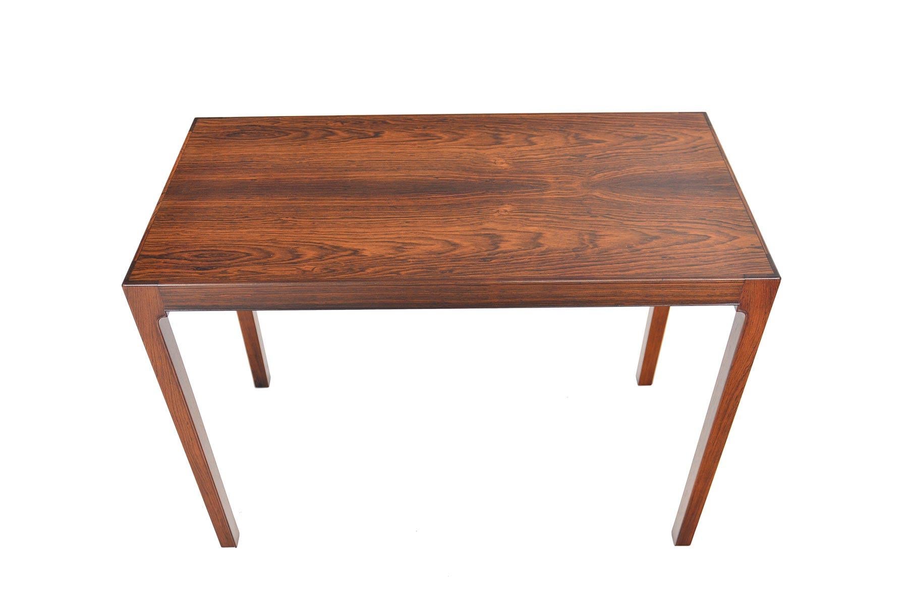 This Danish modern midcentury console table is a rare design. Constructed in Brazilian rosewood, this tall and elegant piece is perfect for any entry, foyer, or living room in need of table height storage. In excellent original condition with