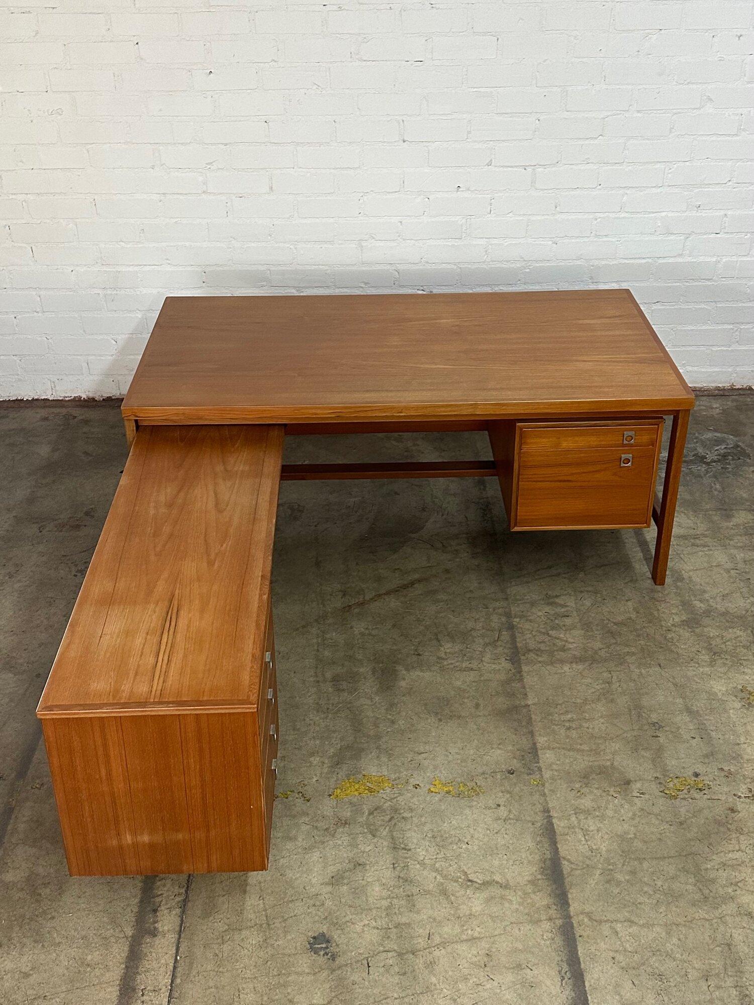 W69 D37.5 H28.5 KC26.5

L W53 D18 H25.5 KC23.5

Danish modern teak L shaped desk by Arne Vodder. Item is structurally sound and shows in great as found condition. Original owner had this item recently refinished. Desk shows with very light sun