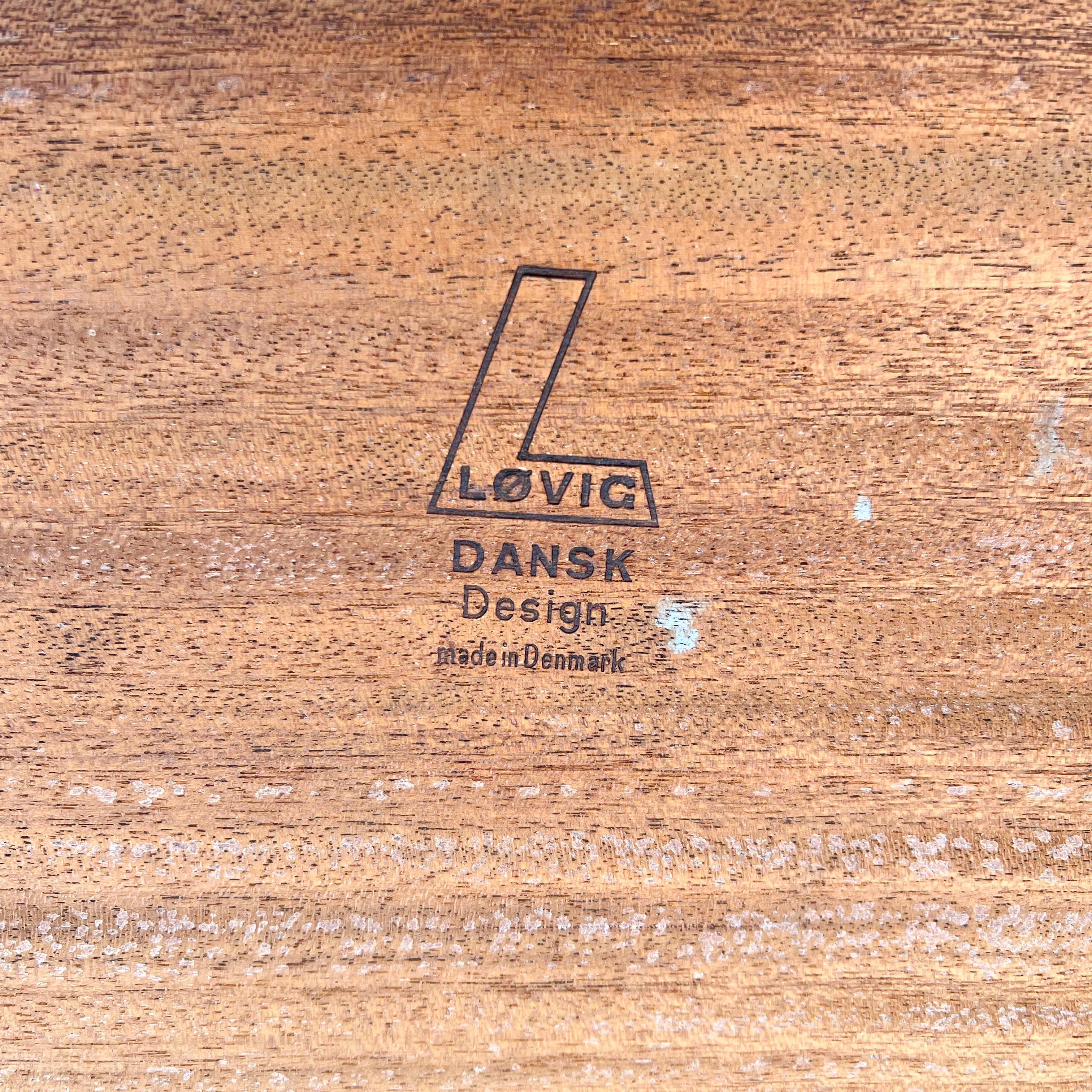 Mid-Century Modern danish teak executive desk with floating top designed by Peter Lovig Nielsen. Open shelving/cabinets in the finished back. Some scuffing and scratching to the teak finish.
