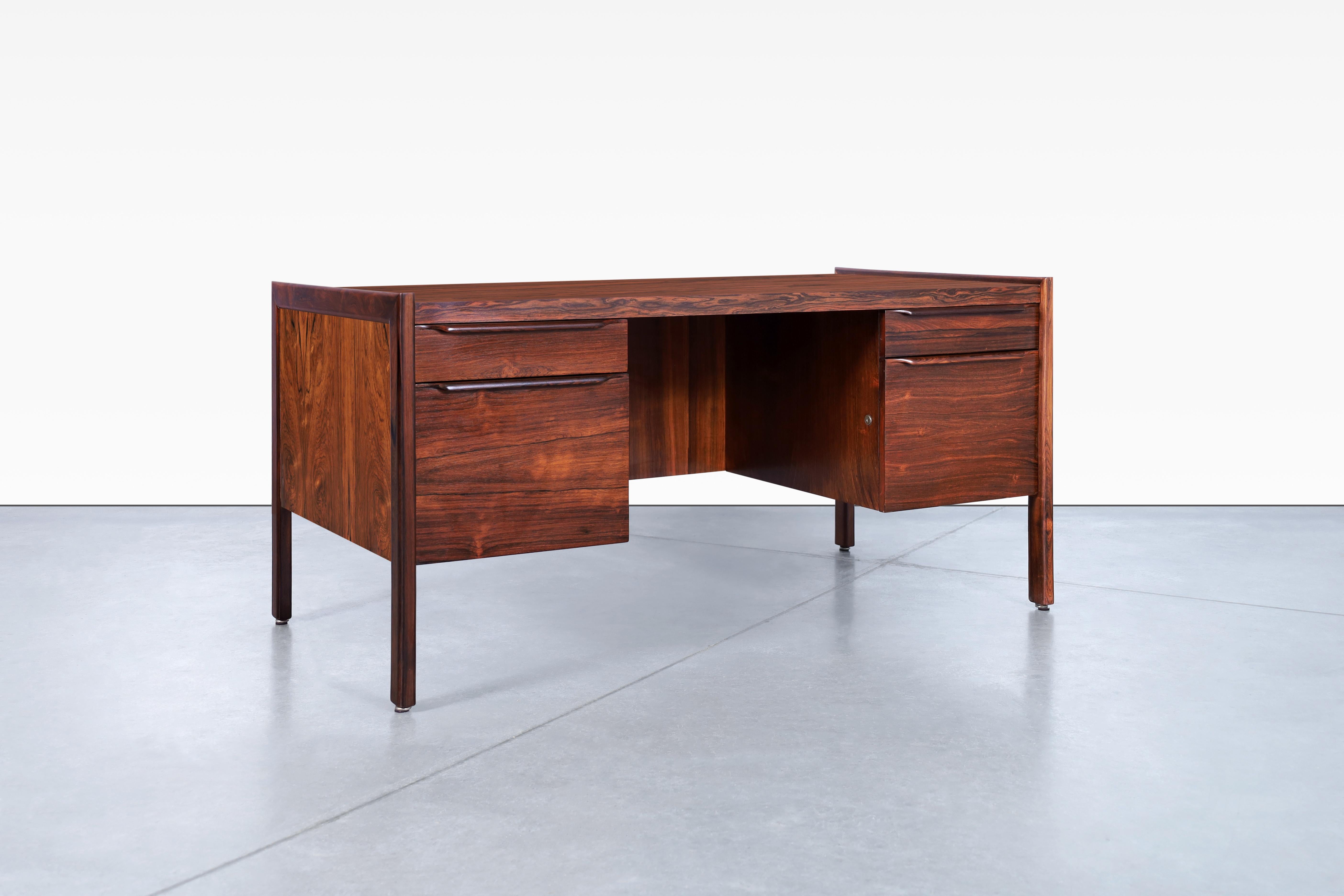 Fabulous Danish modern executive rosewood desk, designed in Denmark, circa 1960’s. The Brazilian rosewood desk has been carefully restored to reveal its natural beauty and incredible grain. Its stunning design is complemented by exquisite