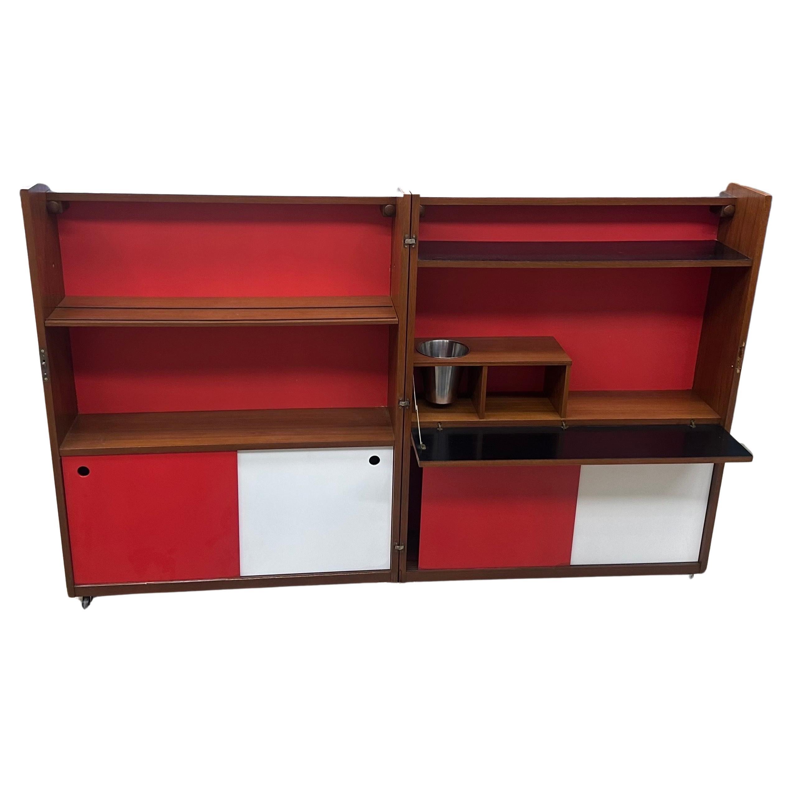 Super cool and unique Danish modern expansion bar cabinet in teak by Johannes Andersen for Drylund, circa 1950s.   This stunning piece of furniture combines functional design with elegant simplicity.  Made from high-quality teak, this bar cabinet