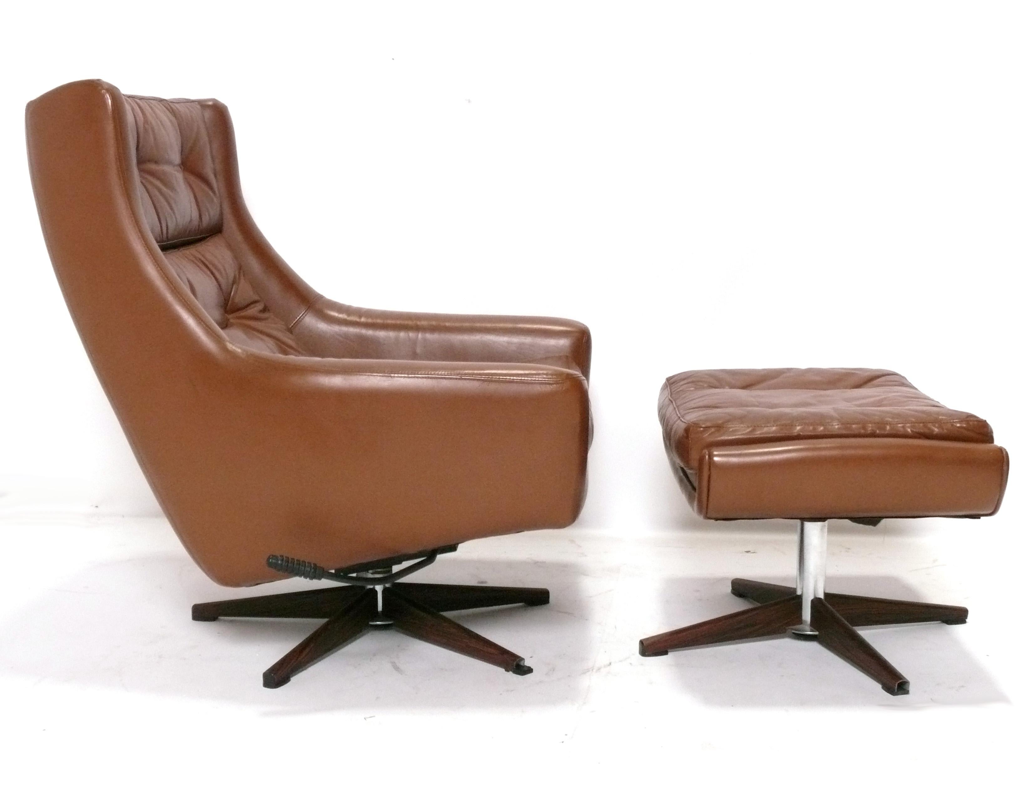Danish Modern Faux Leather Lounge Chair and Ottoman, Denmark, circa 1960s. Usually you get great design or you get super comfortable, but rarely both. This chair is both! Swivel and tilt for maximum comfort. The chair measures 36