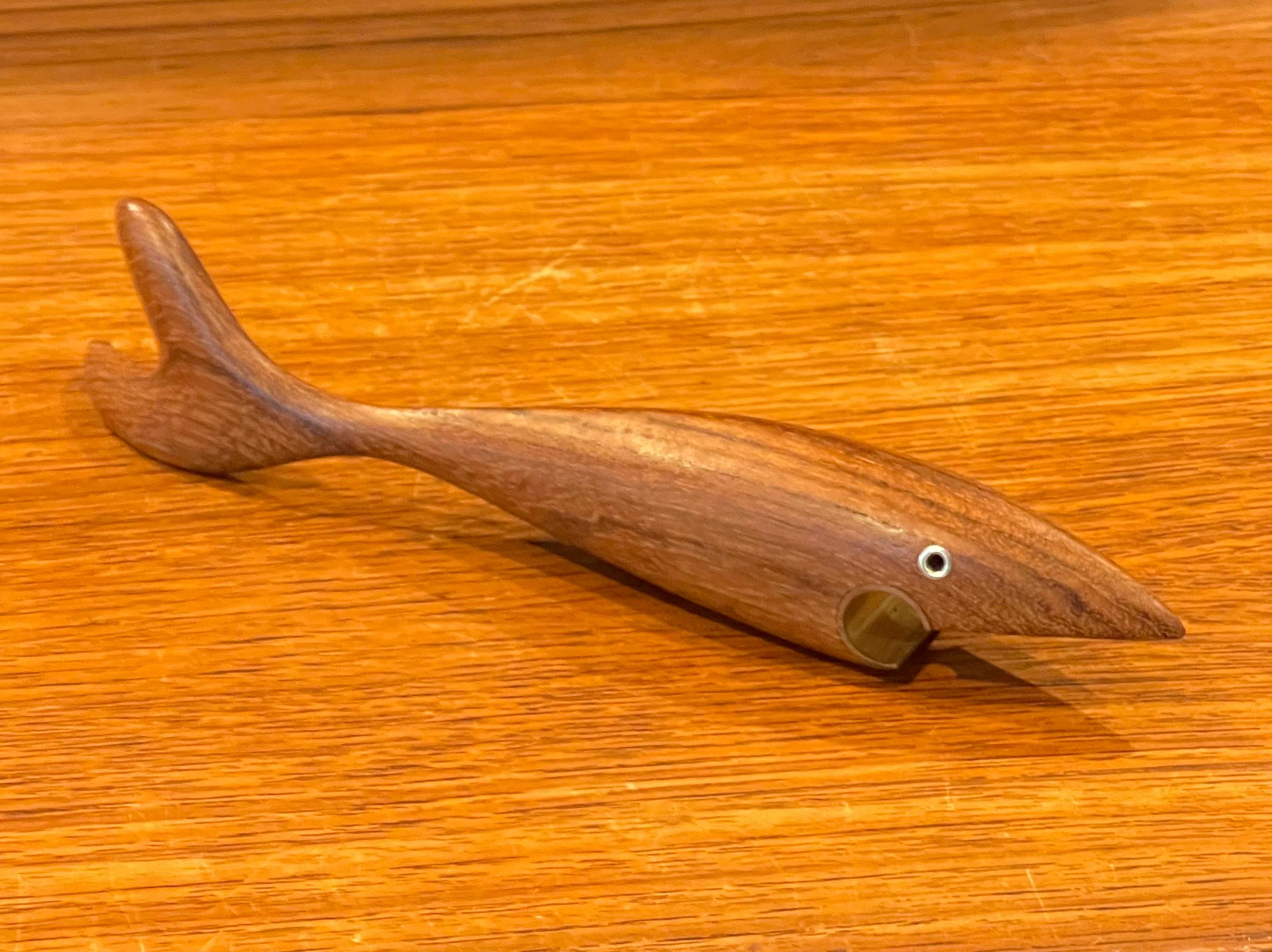 A very cool Danish modern fish shaped teak and brass bottle opener, circa 1960s.  The opener is in very good vintage condition and measures 9