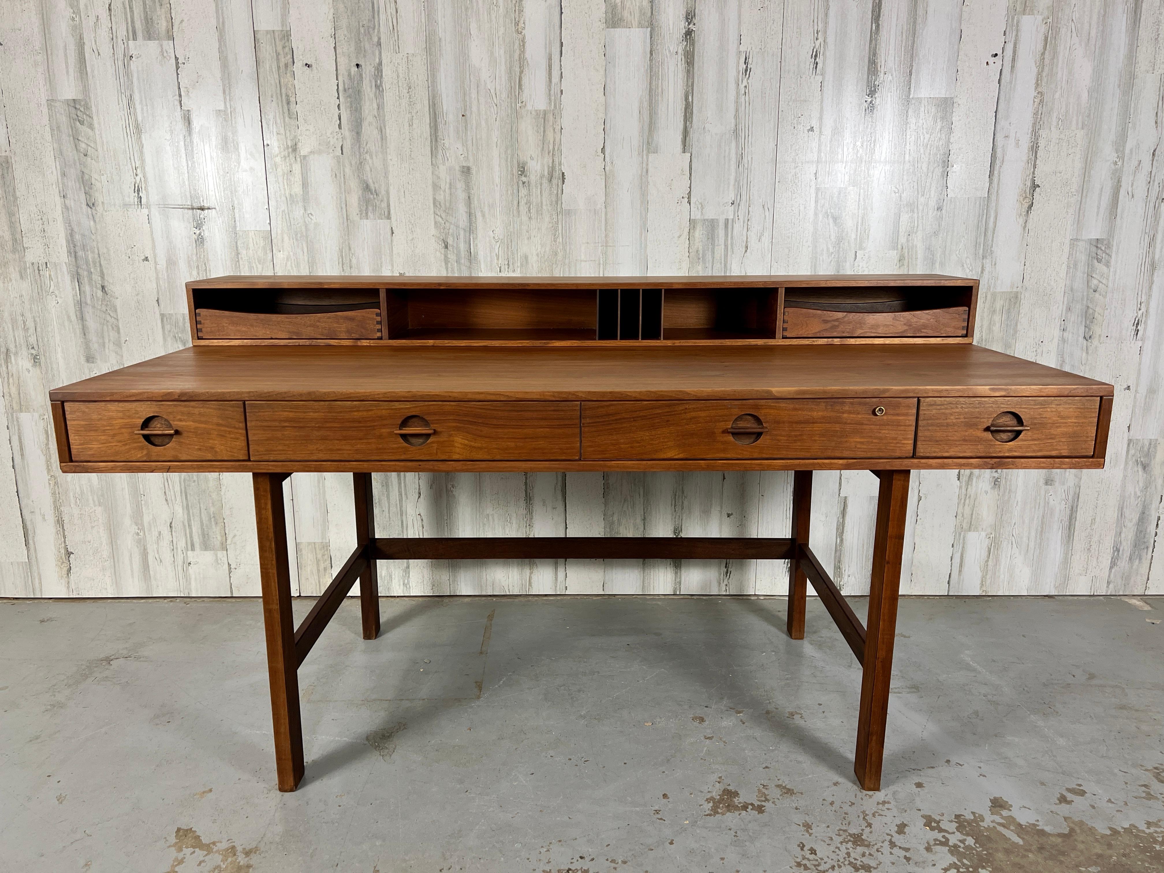 Danish Modern Teak Flip Top Desk by Peter Lovig Nielsen. The top flips down to be transformed into a partners desk or can remain upright for storage. 
When desk is open it measures: 38
