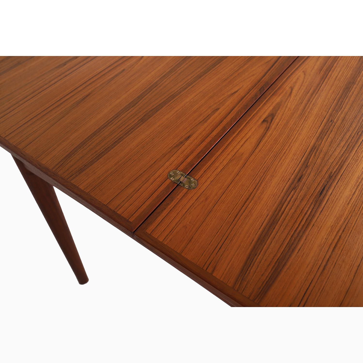 A flip-top style Danish Modern table in old growth teak designed by Børge Mogensen for Søbørg Møbler.  
This square teak table is the perfect size for cards or puzzle-doing on any normal day, and it opens up to double in size when you want to have