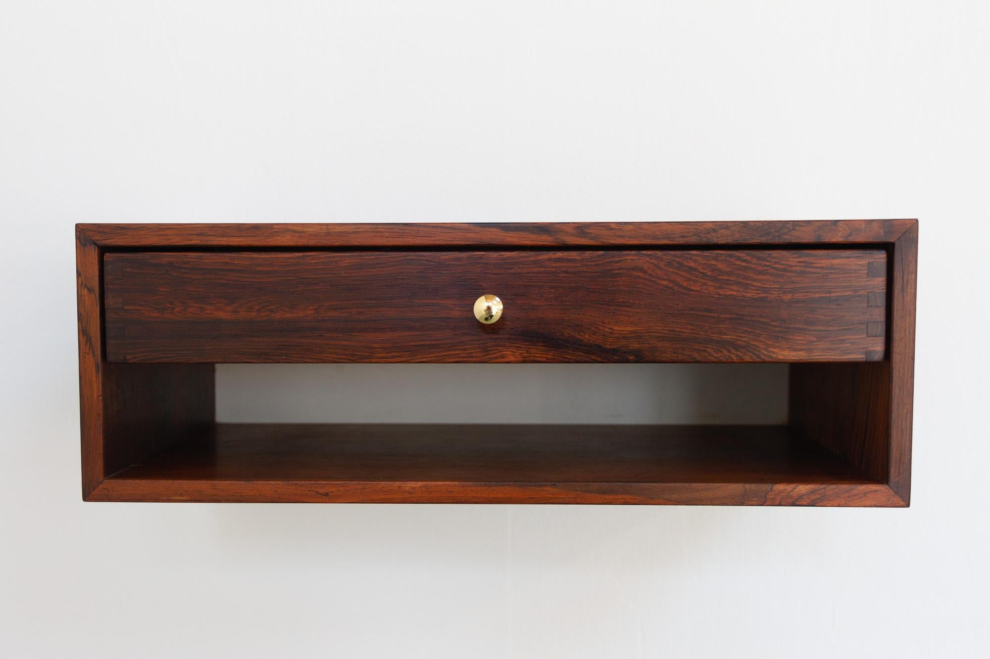 Danish Modern Floating Console by Kai Kristiansen for Aksel Kjersgaard, 1960s.
Elegant and stylish wall mounted shelf with one drawer in beautiful rich and expressive Rosewood veneer. Designed by Danish architect Kai Kristiansen and manufactured by