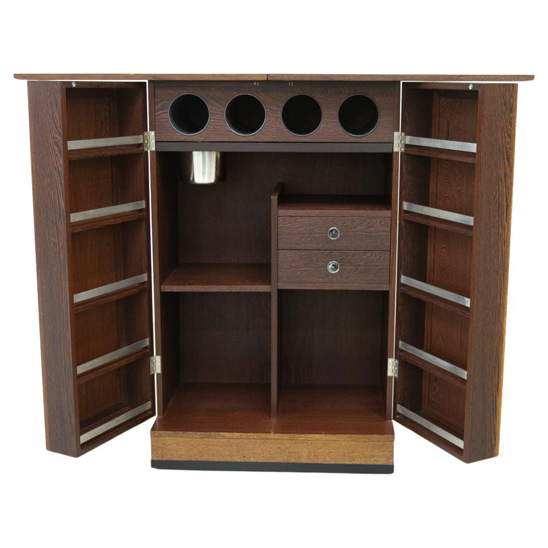 Danish Modern Folding Dry Bar in Wengé by Dyrlund, 1960s. 
Scandinavian Mid-Century Modern rolling fold-up drinks cabinet made in Denmark in the 1960s.
This version of a captains bar by Dyrlund is very rare. It has the top with the pivoting two-leaf