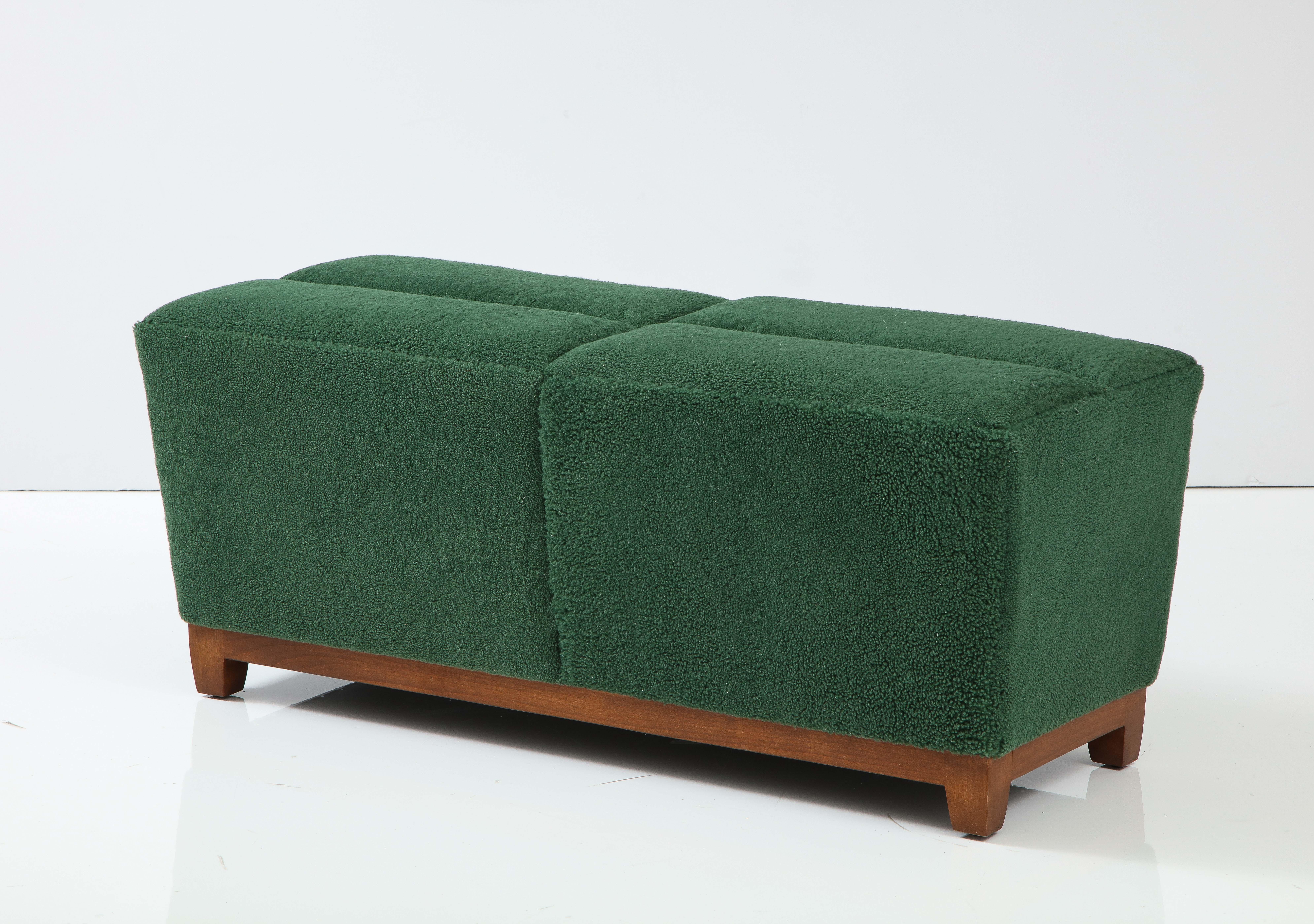 Bespoke Scandinavian Modern bench custom upholstered in dense forest green sheepskins. Bench rests on sold cherry frame and seat crown has a slightly quilted effect.
Mint restored.