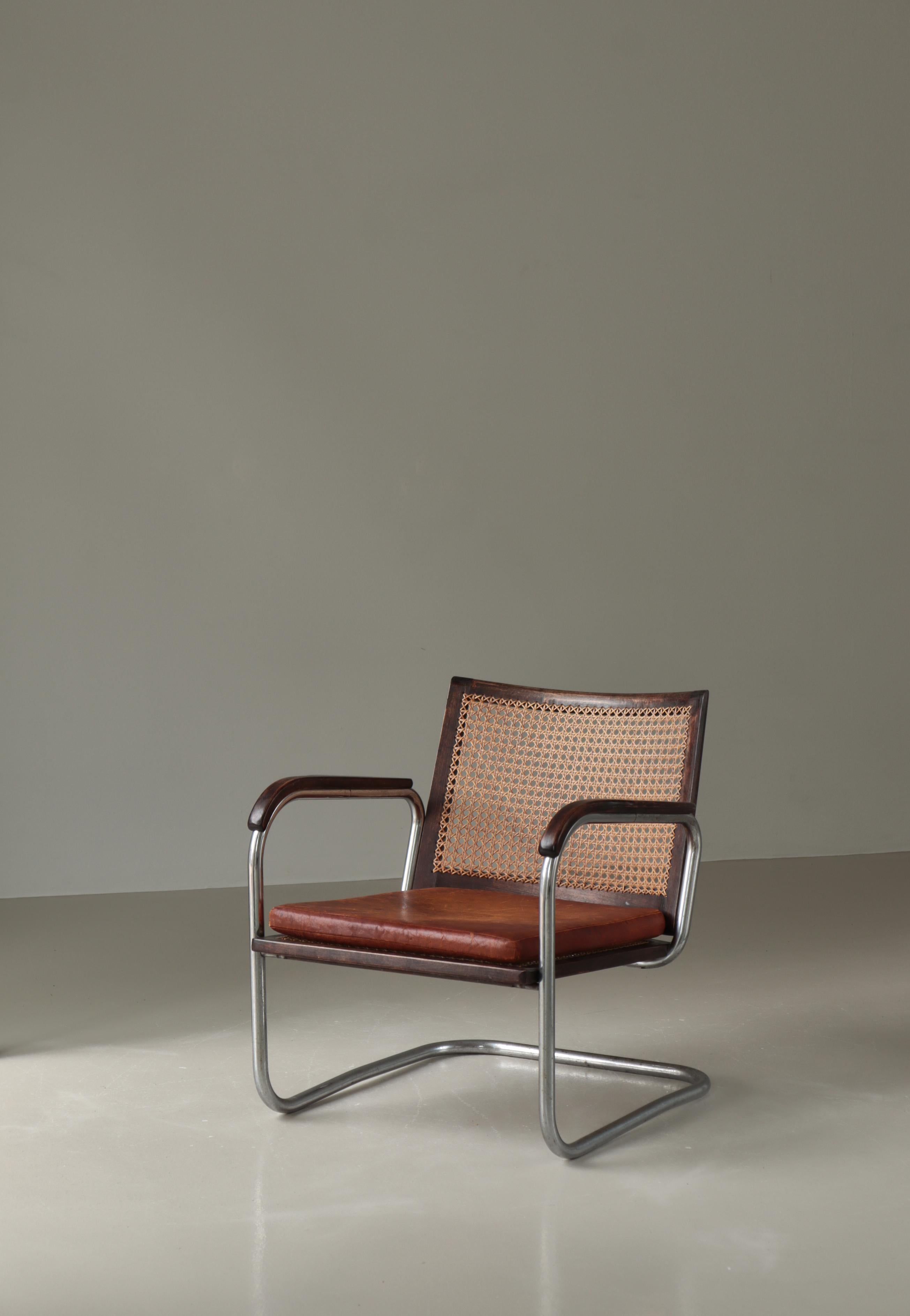 Très ancienne et importante chaise longue modèle S102 en acier tubulaire et hêtre teinté avec canne française d'origine et coussin en cuir. Conçu dans les années 1930 par Frits Schlegel (att.) pour Fritz Hansen. La chaise est dans un état