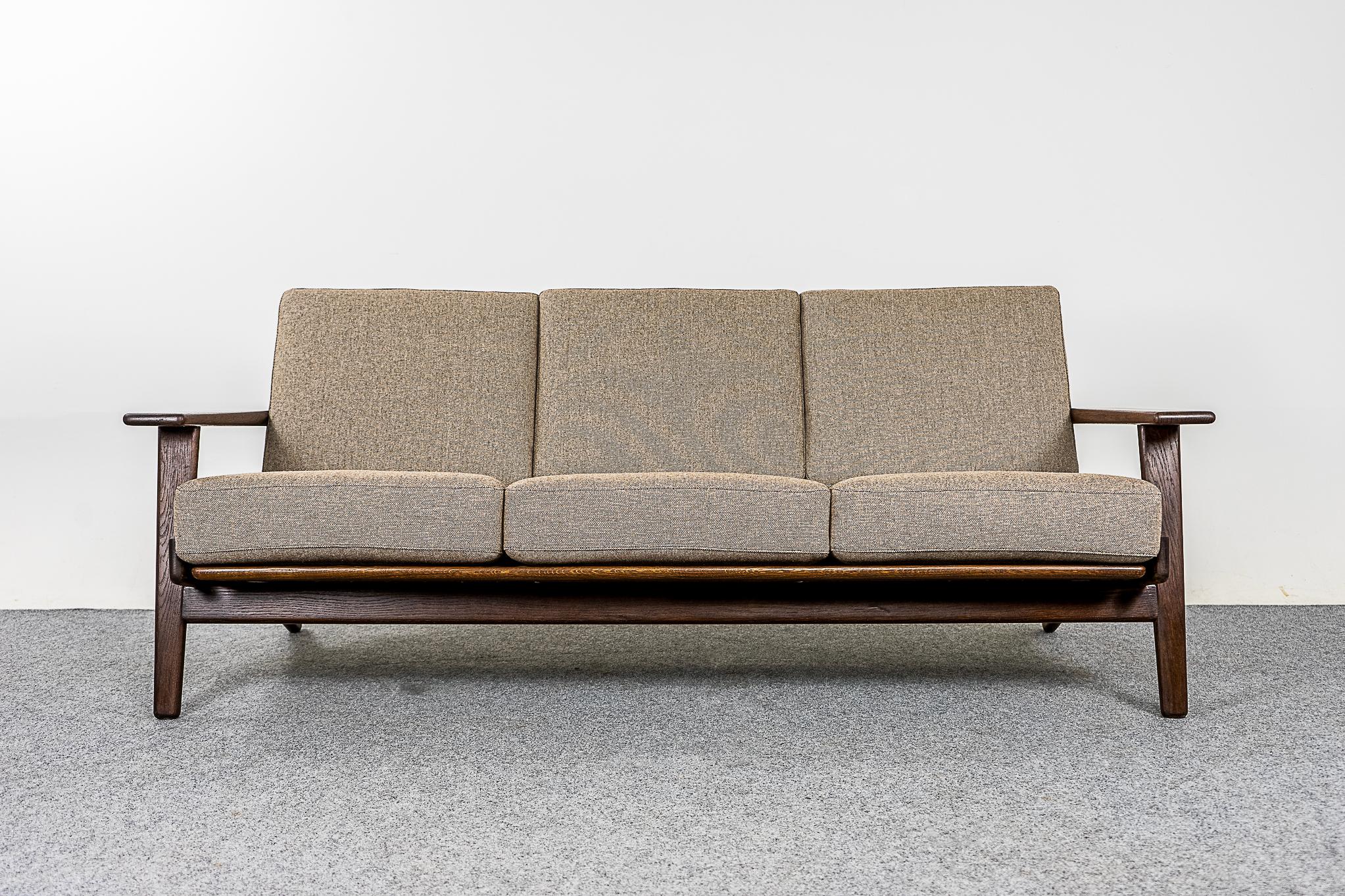 Oak GE 290 sofa by Hans Wegner for GETAMA, circa 1950's. Elegant, robust Danish 3 seat solid frame with stunning lines. Seat deck has the original springs, a very comfortable sitting experience. All new wool & flax blend upholstery, pristine