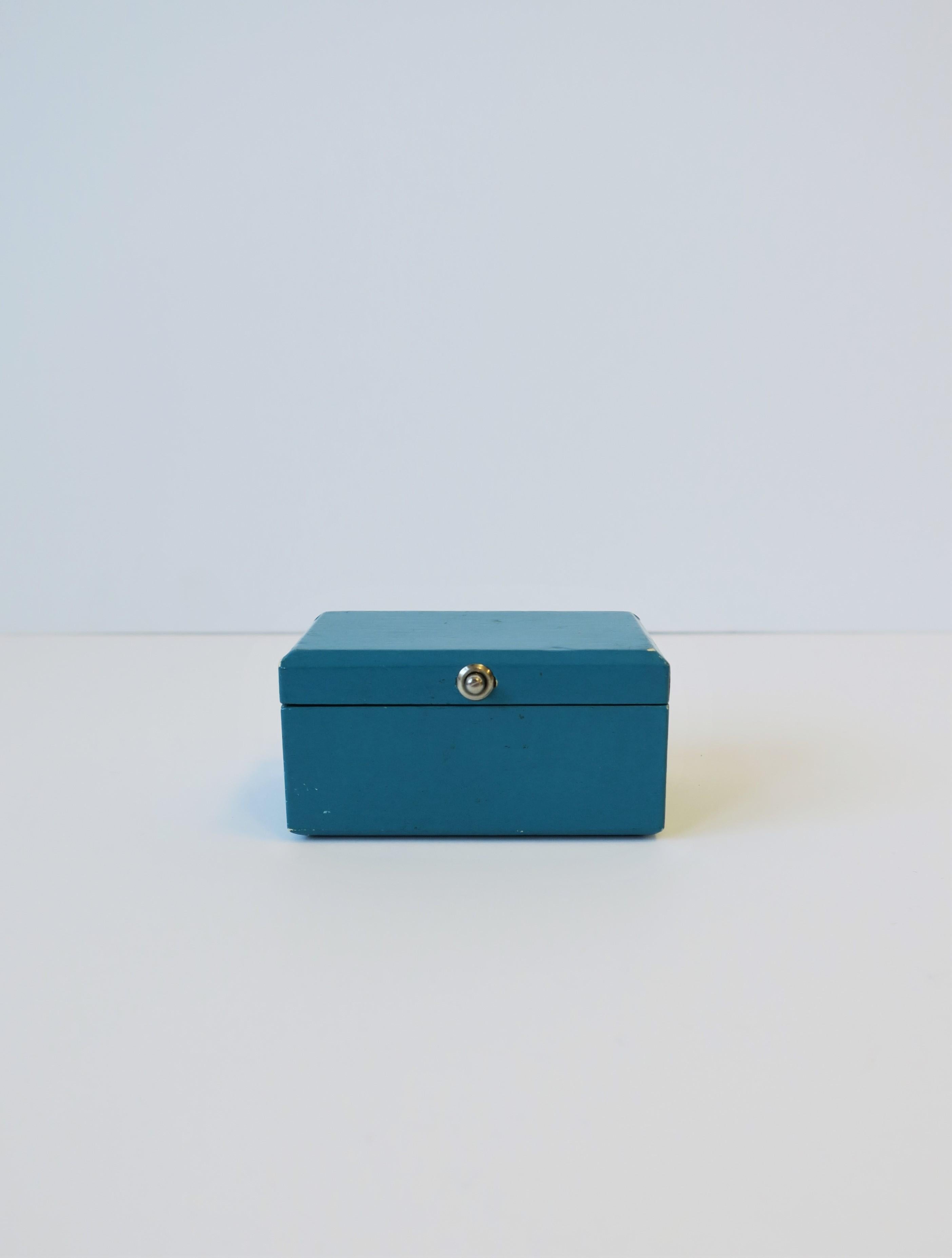 A vintage Danish modern Georg Jensen small rectangular teal blue jewelry box, circa mid-20th century, Denmark. Box from Danish luxury jeweler Georg Jensen is 'wrapped' in a teal blue lacquered paper, a soft cushion inside bottom with 'Georg Jensen'