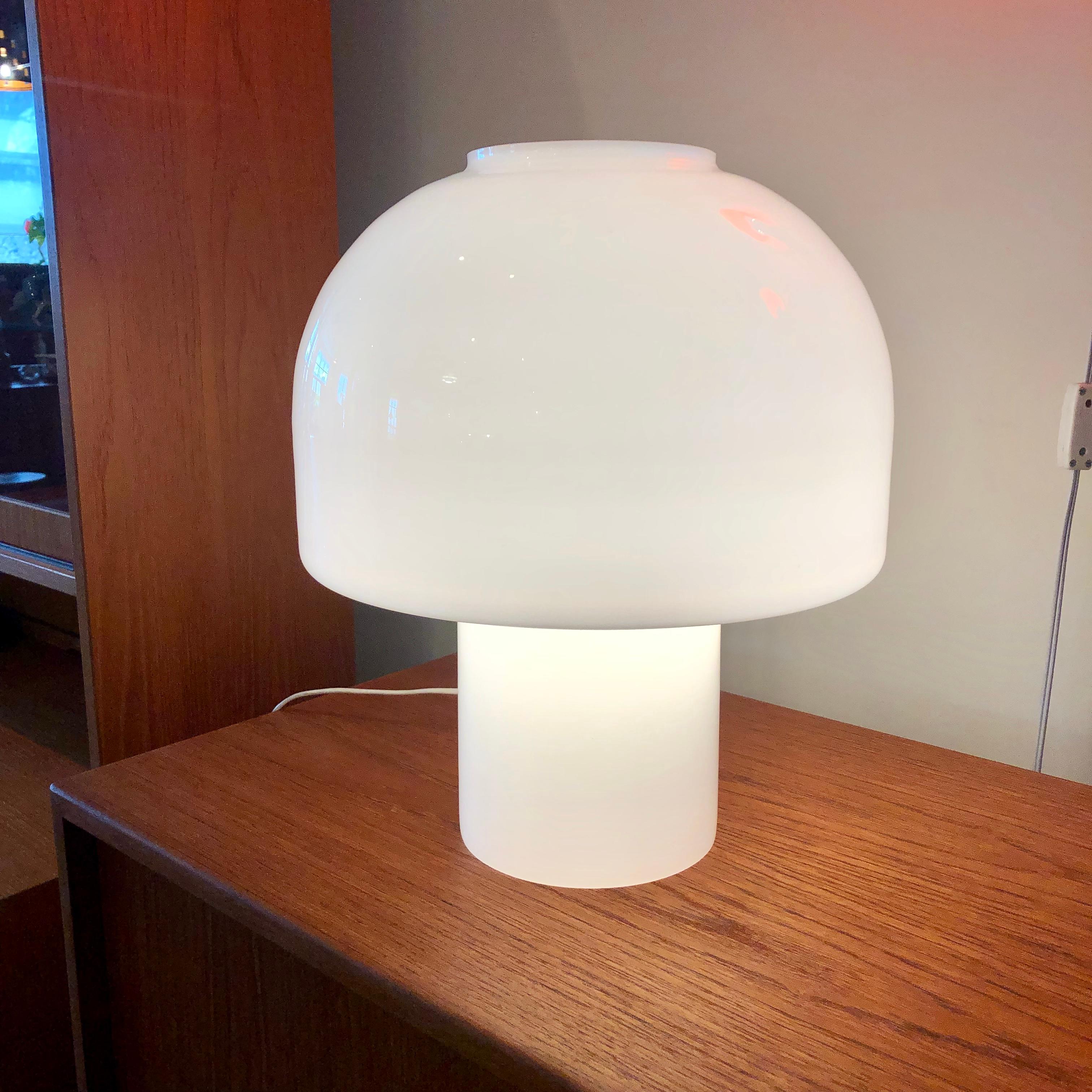 Mushroom shaped milk glass casts a soft glowing light.