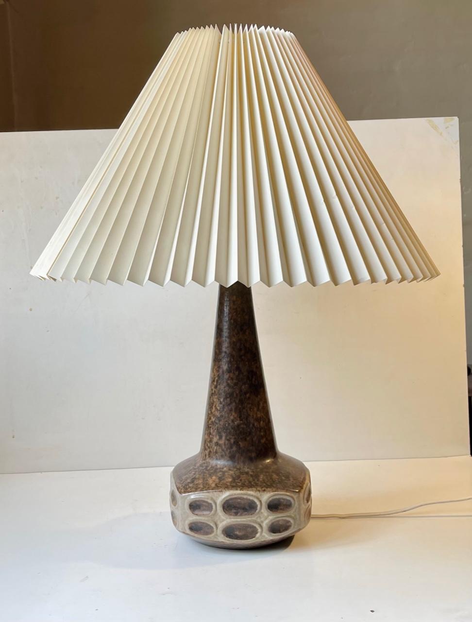 Large ceramic table lamp designed by Marianne Starck for Michael Andersen & Son, Denmark - circa 1970-75. Decorated with earthy brown and pastel glazes. It features its original bakelite socket with pin on/of switch. The height of 22 inches (55 cm)