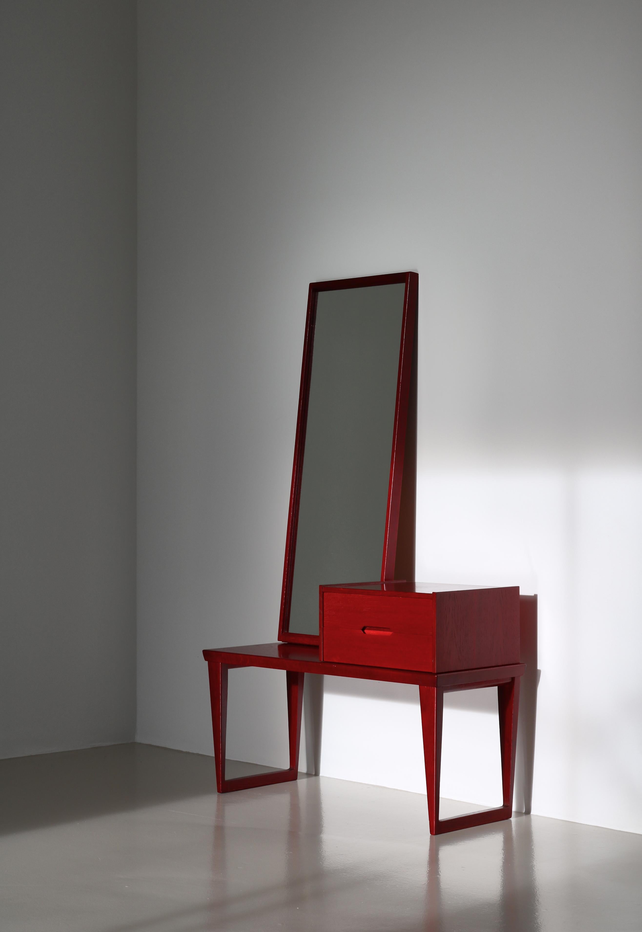 Rare Danish Modern hallway set consisting of a bench, a mirror and a small chest of drawers all designed by Kai Kristiansen in the 1960s.. This example is made of red stained oak and is very rarely seen. It was manufactured in small numbers by Aksel