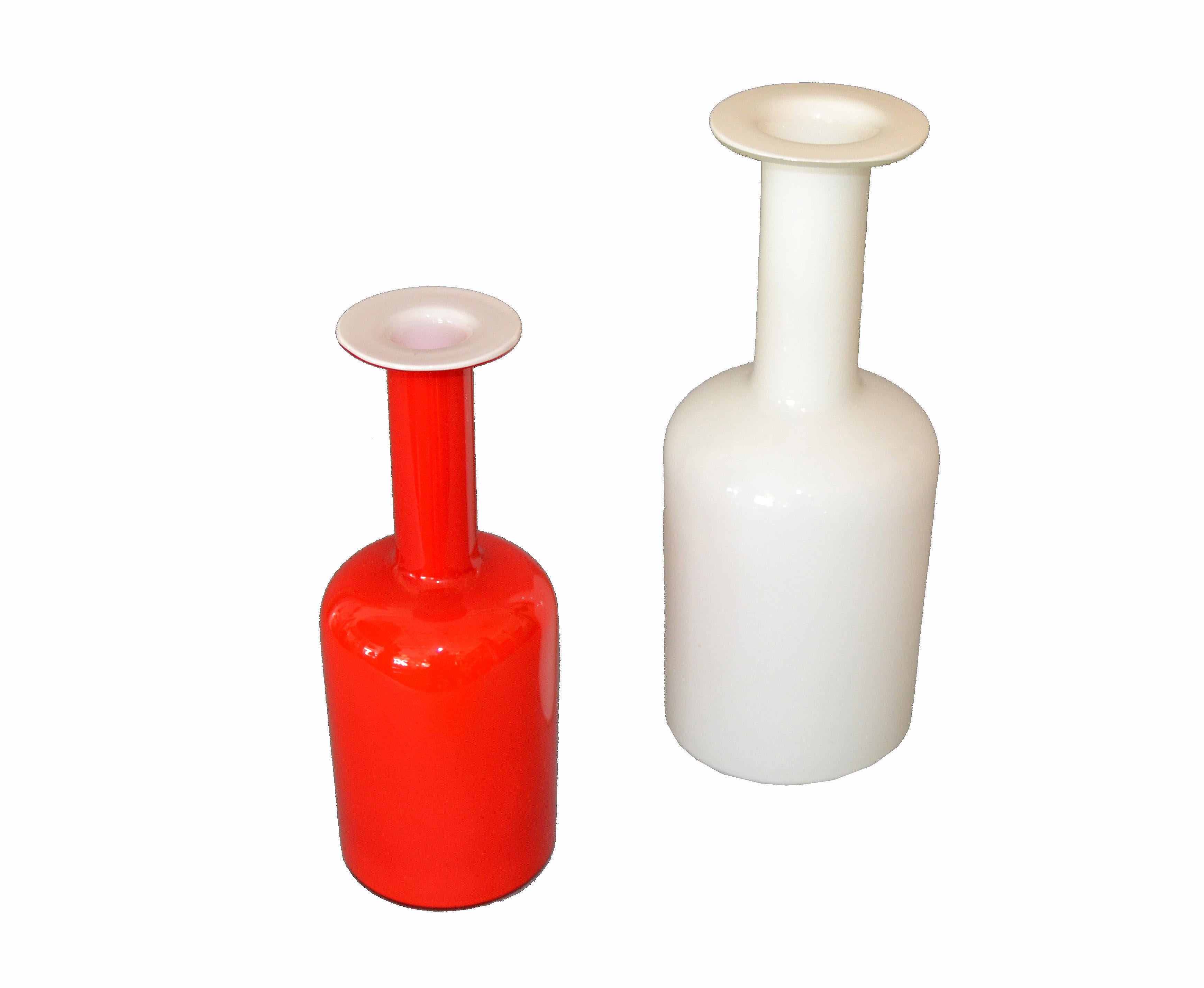 Two hand blown Gulv Vases in red and milk glass cased in white, designed by Otto Bauer and made by Holmegaard in Denmark.
Both vases have the original makers mark.
Iconic art glass from the 1960s design.
Measurement red vase:
Height 10 inches,
