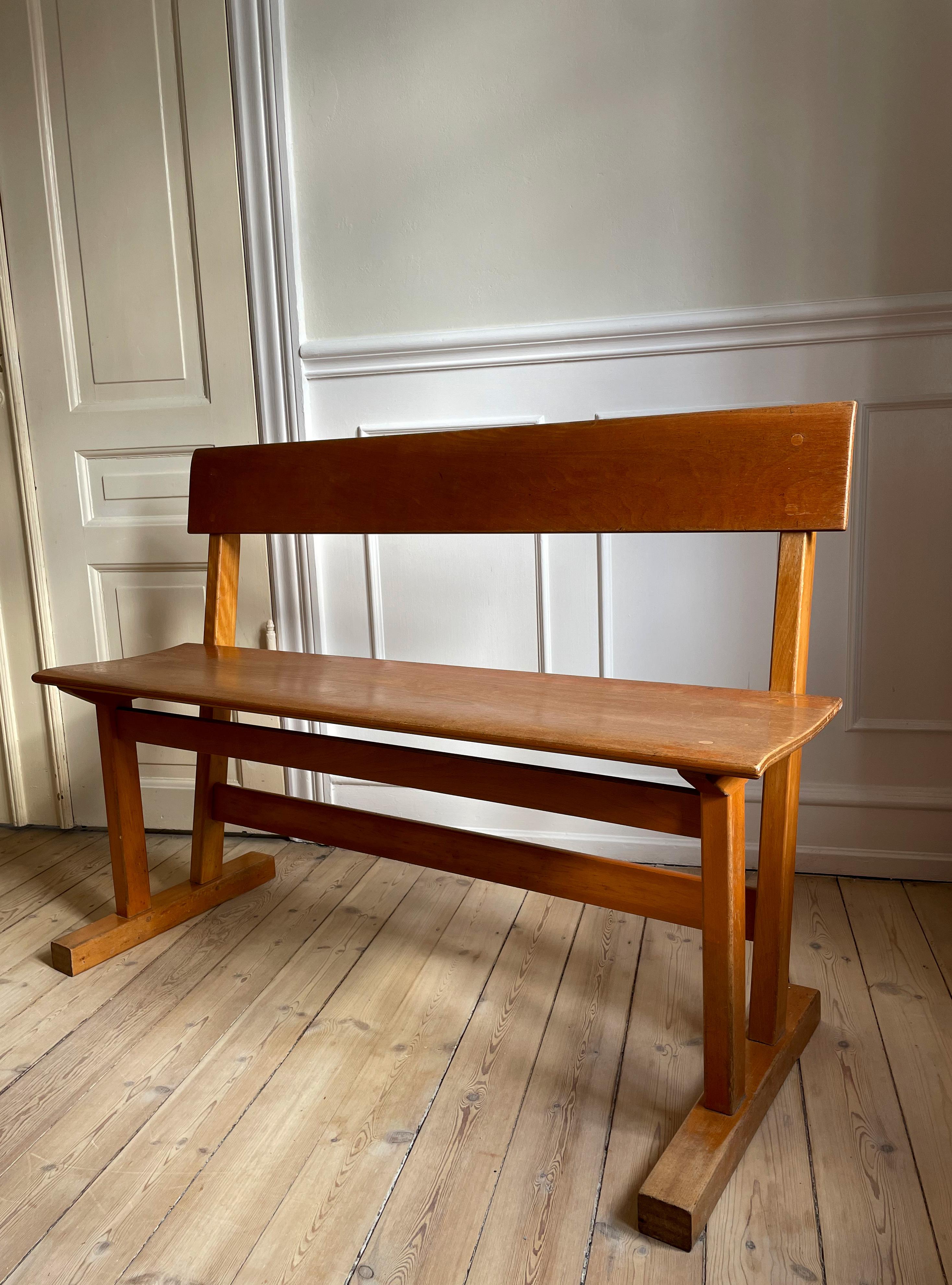 Handmade midcentury Danish modern wooden bench with a slightly higher seat than the average dining chair. Solid, stable designed construction with slight curved slant in seat and back rest, beautiful joints and a classic minimalist aesthetic. A