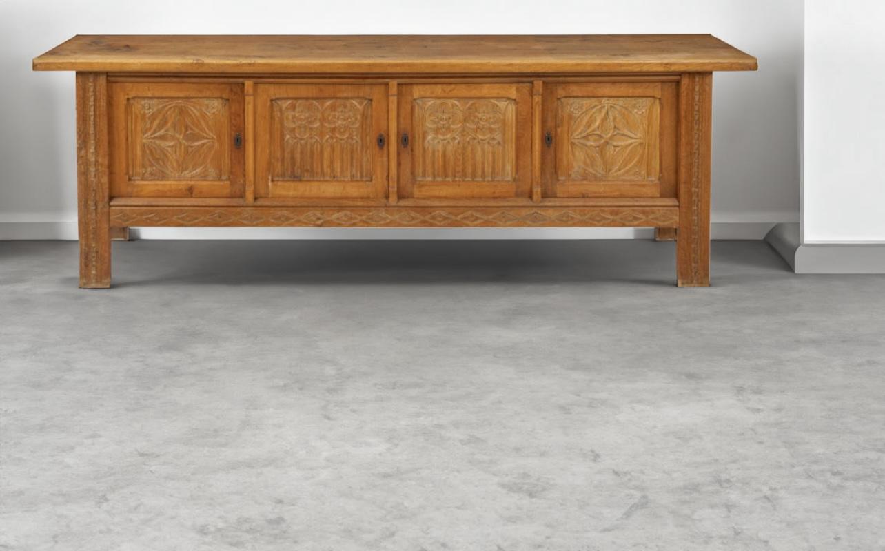 Beautifully detailed Danish modern brutalist solid oak sideboard designed by Henning Kjærnulf features hand-crafted details within the doors and legs. There are three storage compartments with two shelves and three shelves on the far right.