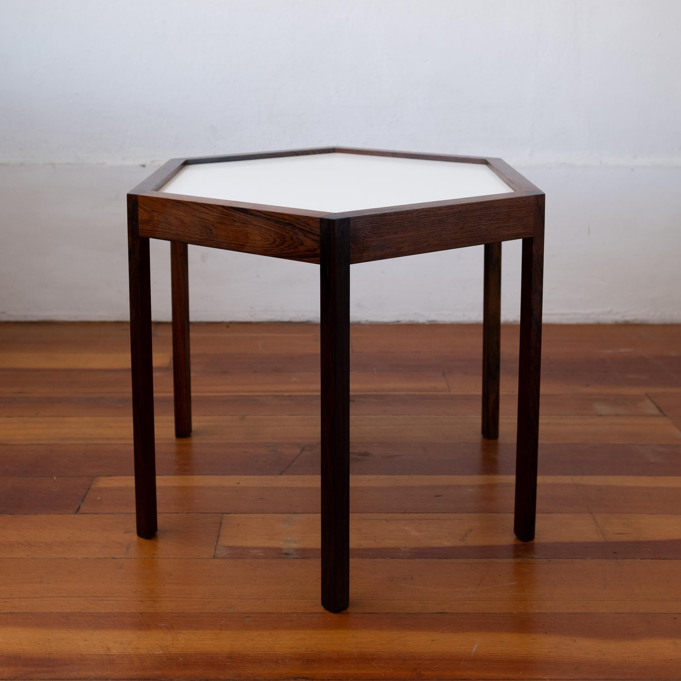 Hexagon rosewood occasional table by Hans C. Andersen. White laminate top. Excellent detailing and craftsmanship. Signed. Denmark, 1960s.