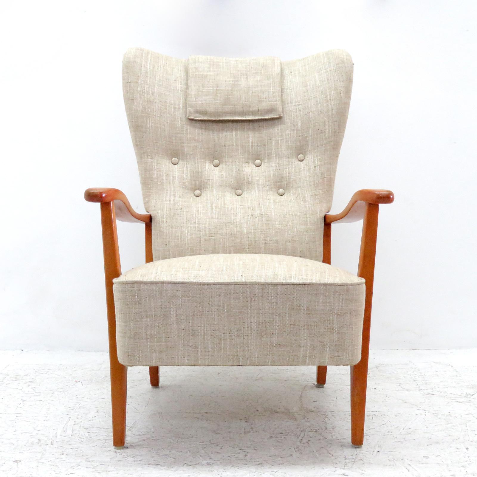 Wonderful Danish modern high back chair by DUX, 1940, sculptural stained beech frame with professionally reupholstered body, the concave wing back is tufted and the seat is spring supported, with detachable head rest cushion, marked. (See also